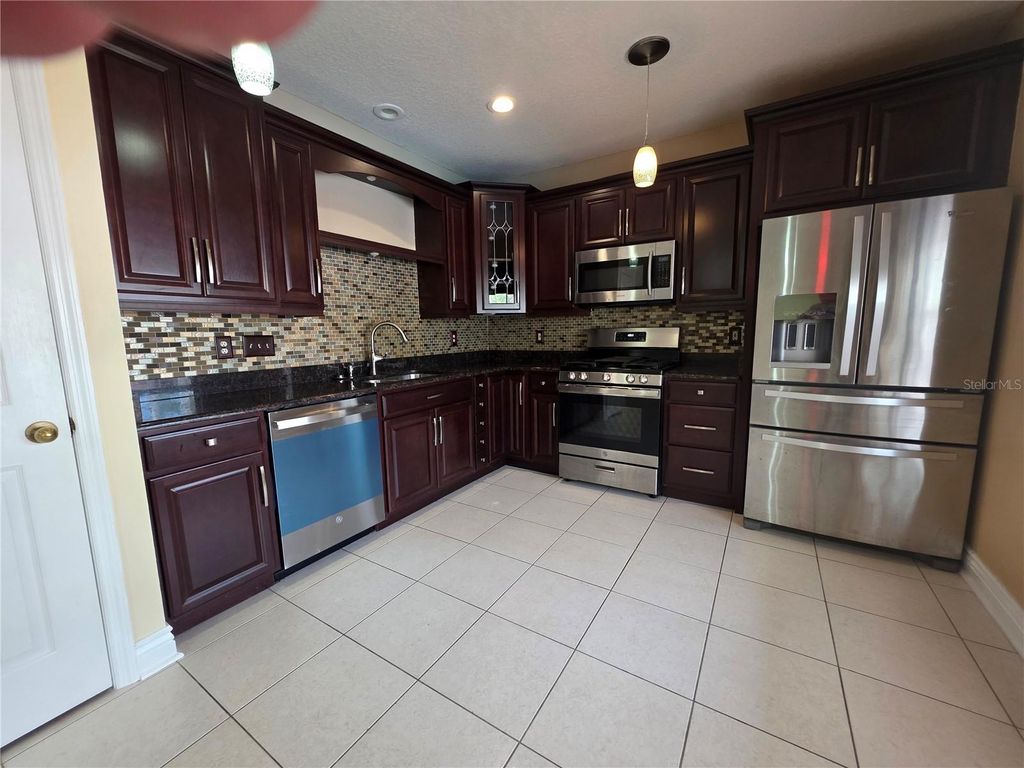 Photo of 1690 Meadow Oak Lane, Tarpon Springs, FL 34689 (MLS # TB8505114)