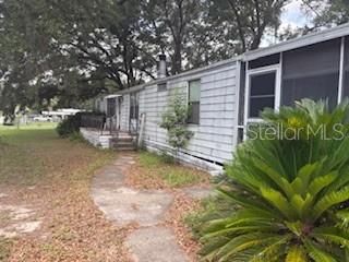 *** Yes this has been Reduced and Ready for you***
This home sits on nearly a three quarter-acres. This 3 bedroom 2 bath home is perfect Investor/Handyman special. The potential to subdivide into 3 lots, NO HOA, NO age restrictions, and NO limitations on short-term rentals—a perfect fit. This home offers 1,729 square feet of living and extra storage space (garage area around the back) indoor laundry room. A side area lanai off of the front bedroom. A large screened lanai at the back of the home. The location convenience of being just minutes from The Villages, Lake Weir, Belleview as well as top-notch healthcare in The Villages, shopping, and dining along the 441 /42 corridor. This home is an easy walk to Dining, Gym facilities, Pet groomers, Convenience stores and more..... LOCATION IS KEY! This well-located property is ready to welcome its new owners—don’t miss out, schedule your private showing today!