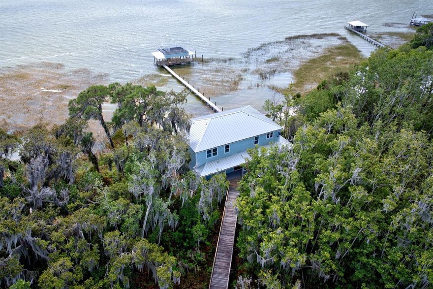 " Waters Edge" on Lake Placid Lakefront Escape on 3.15 Acres – Boathouse, Boardwalk & Breathtaking Views Experience the ultimate lakefront lifestyle on 3.15 private acres along the shores of Lake Placid. Tucked beneath a canopy of trees, this one-of-a-kind retreat welcomes you with a scenic boardwalk entrance and unmatched privacy from the moment you arrive. Designed in timeless Key West style, the home features a wraparound porch, metal roof, and exceptional craftsmanship throughout. Inside, natural light fills the space through expansive windows, showcasing stunning lake views from nearly every room. The open living areas, custom kitchen, and warm architectural details present the perfect blend of comfort and elegance. This home features 4 bedrooms with the potential for a 5th bedroom, along with 3.5 bathrooms, offering flexible space for guests, a home office, or growing needs. With two primary suites and multiple indoor and outdoor living areas, it is ideal for both everyday living and entertaining. Step outside to your private boathouse with lifts, composite decking, and panoramic water views—perfect for boating, hosting, or simply unwinding on Lake Placid. This is more than a home—it’s a private lakefront retreat.