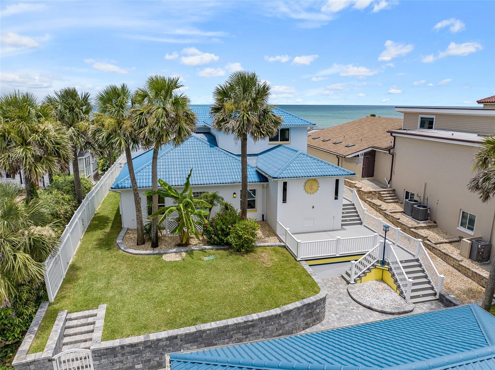 Oceanfront Oasis in the Hearth of Ormond Beach. Located high on a dune directly across from Oceanside County Club offering endless views of the Atlantic ocean and the pristine NO DRIVE BEACH. Interior features include 4 or 5 bedrooms (5th bedroom currently used as a media room) 4 full bathrooms with an additional ½ bath poolside. The primary suite is located on the top floor with private balcony overlooking the pool and ocean. Pool parties are mandatory around the oceanfront resort style saltwater pool which was constructed to the highest standards utilizing pilings and features fountains and a sun shelf which can accommodate multiple lounge chairs. The pool deck is imported travertine and accented by a summer kitchen and gas fire pit. The elevation of this property is evident as you traverse your private beach walkover which extends down 2 tiers to the beach featuring a concrete seawall and coquina riprap on the lower level. The 3 car detached garage has individual bays and additional storage space. Some of the updates over the past few years include the GrandeTile energy efficient metal barrel style roof, impact doors and PGT windows throughout, AC units, hot water heater, extensive paver driveway and retaining wall and Kohler 38KW whole home generator with 500 gal buried propane tank. This home is ready for it’s new owner to put their personal touches on this slice of paradise!!