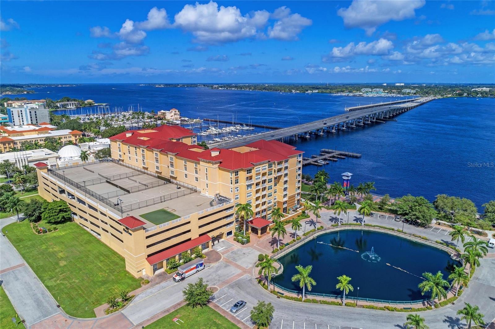 IT'S TIME...Time to trade those cold cloudy days up north for warm sunny skies on Florida's Gulf Coast...Time to sell the snapper and let someone else do the yard work...Time to hit the links, go fishing or take a walk on the beach...Time to finally Make the Move!!! Come take a look at this Affordably Priced Condo and you may find you've finally made the Right Choice! Conveniently located on the River Walk in downtown Bradenton this amazing unit in River Dance features; A spacious Great Room floor plan ideal for entertaining new found friends, and offers a dining area with a view! The cozy kitchen with Gold Stone Granite counters is perfect for creating culinary delights, offers ample storage with 36" oak cabinets, Stainless Steel Appliances (of course), Tumbled Tile back splash, a full size walk in pantry and a breakfast bar ideal for that morning cup of coffee or lunch on the go. The Primary Bedroom features a walk in closet, French door access to the Screened Lanai, luxury vinyl flooring and an ensuite bath with twin sinks, a tub and shower and a private water closet. The Guest Bedroom is separate and private and the DEN/OFFICE is ideal for self employed or those who work remotely. Tile on the diagonal, Crown Molding adds a touch of Class, UPDATED WONDOWS, NEW AC, no deferred maintenance here! Amenities at River Dance include: A HEATED POOL AND SPA, for swimming all season long, a Fitness Center to keep in shape, an In House Theatre with a monthly feature length films for residents, Conference Room, Tennis, Pickle Ball and Basketball courts, Secured Entry, Two apartments in the building for visiting Family or Friends, Covered Gated parking and this unit (one of only four in the building) even has an EV ELECTRIC CHARGING STATION!!! Easy access to the RIVER WALK is perfect for walking or an occasional run, Day Docks adjacent to the property make private boating a pleasure and easy to enjoy, Fine Dining is a short walk away and there's even access to the City owned WATER TAXI for a quick trip out to Anna Maria Island. The BEACHS are calling your name...This is your year so call today and start home tomorrow.