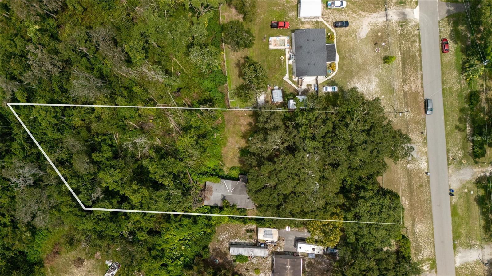 This unique multigenerational property offers two separate homes—each equipped with its own septic system and electric panel—providing excellent flexibility for extended family, guests, or rental income. The main double-wide home has been fully gutted and is in the middle of a complete renovation (not livable), giving you the chance to finish it exactly to your tastes. The single-wide home needs some love but is livable, with functioning electric, water, and septic systems—it was recently lived in and remains in working condition. Plates and labels for both homes are available should you choose to keep them.
Enjoy the freedom of no HOA—bring your vision, your toys, and your lifestyle without limitations! This property is ideally located at the end of a quiet cul-de-sac, offering minimal traffic and enhanced privacy thanks to a peaceful wooded backdrop. Thoughtfully positioned on the lot, the home allows for easy access and plenty of space to accommodate RVs, boats, work trucks, or other large vehicles with room to spare in the backyard.