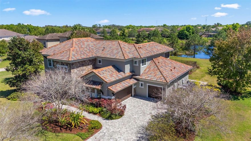 Rare custom estate on nearly an acre with serene pond views and a resort-style pool—this is the private Florida lifestyle buyers are searching for.

Welcome to this stunning residence, perfectly situated on an expansive .79-acre homesite. Designed for both luxury living and effortless entertaining, this home offers 5 bedrooms or 4 bedrooms plus a bonus room, dedicated office, separate dining, and 4 full baths, all enhanced by soaring volume ceilings and impeccable craftsmanship.

The thoughtfully designed floor plan includes an additional bedroom on the first floor, along with a luxurious primary suite featuring direct access to the outdoor living space. Rich hardwood flooring spans the entire first floor, complemented by elegant 8-foot doors throughout.

The gourmet kitchen is a true showpiece, featuring premium Viking appliances, quartz countertops, farmhouse sink, custom stacked cabinetry with glass-front uppers and interior lighting, a large island, and a sunny eat-in area. The kitchen flows seamlessly into a generously sized family room with volume ceilings, creating the perfect gathering space. The 1st floor is complete with a full laundry room with folding table and utility sink adds everyday convenience.


Upstairs, you’ll find two additional bedrooms and an enormous bonus room, all with custom built-out walk-in closets. 
Step outside to your private oasis—an open-air heated pool and spa overlooking tranquil water views, complete with a gas fireplace, new retractable lanai screens, and multiple seating areas. The space is fully enclosed with a new wrought iron fence for added privacy and elegance.

Additional highlights include custom closet systems, plantation shutters, custom window treatments, and a $20K designer front door, along with refined finishes and abundant natural light throughout.

This is more than a home—it’s a lifestyle of comfort, sophistication, and privacy in one of Tampa’s most desirable settings.