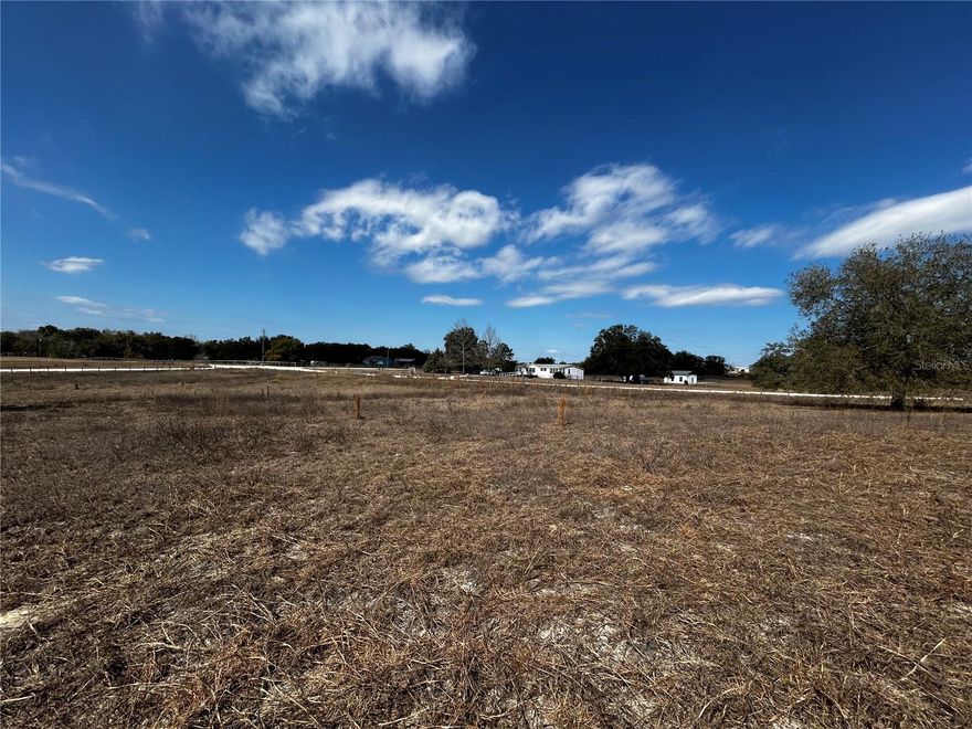 5 ACRES WITH ELECTRIC, WELL, SEPTIC AND FULLY FENCED in TRENTON, FL! Welcome to Gilchrist County - THIS is what you're looking for! FIVE fully fenced acres on a corner lot, with access to Christmas Lake and Dinner Pond. Electric, well, and septic are fully connected and waiting for you to put a manufactured home or build on this lot! There is NO HOA, but there are minimal deed restrictions. Horses and cows are allowed. Not only do you have lakes in your neighborhood, but just a short drive away are the Springs and the Suwannee River! Enjoy Hart Springs and Otter Springs. You're also a short drive to Newberry, which has Publix and other shopping and dining. Trenton also has a lot to offer, come explore the area and see all that there is for you to enjoy! This property currently has a manufactured home on it, but the value is attributed to the land and the utilities as the home is a fixer upper and needs TLC. Sold AS-IS. Come take a look, this is what everyone is searching for!! Just a little labor of love is needed to spruce up the yard and you can have your garden, an area for your horse(s) and cow(s), and whatever else you desire!