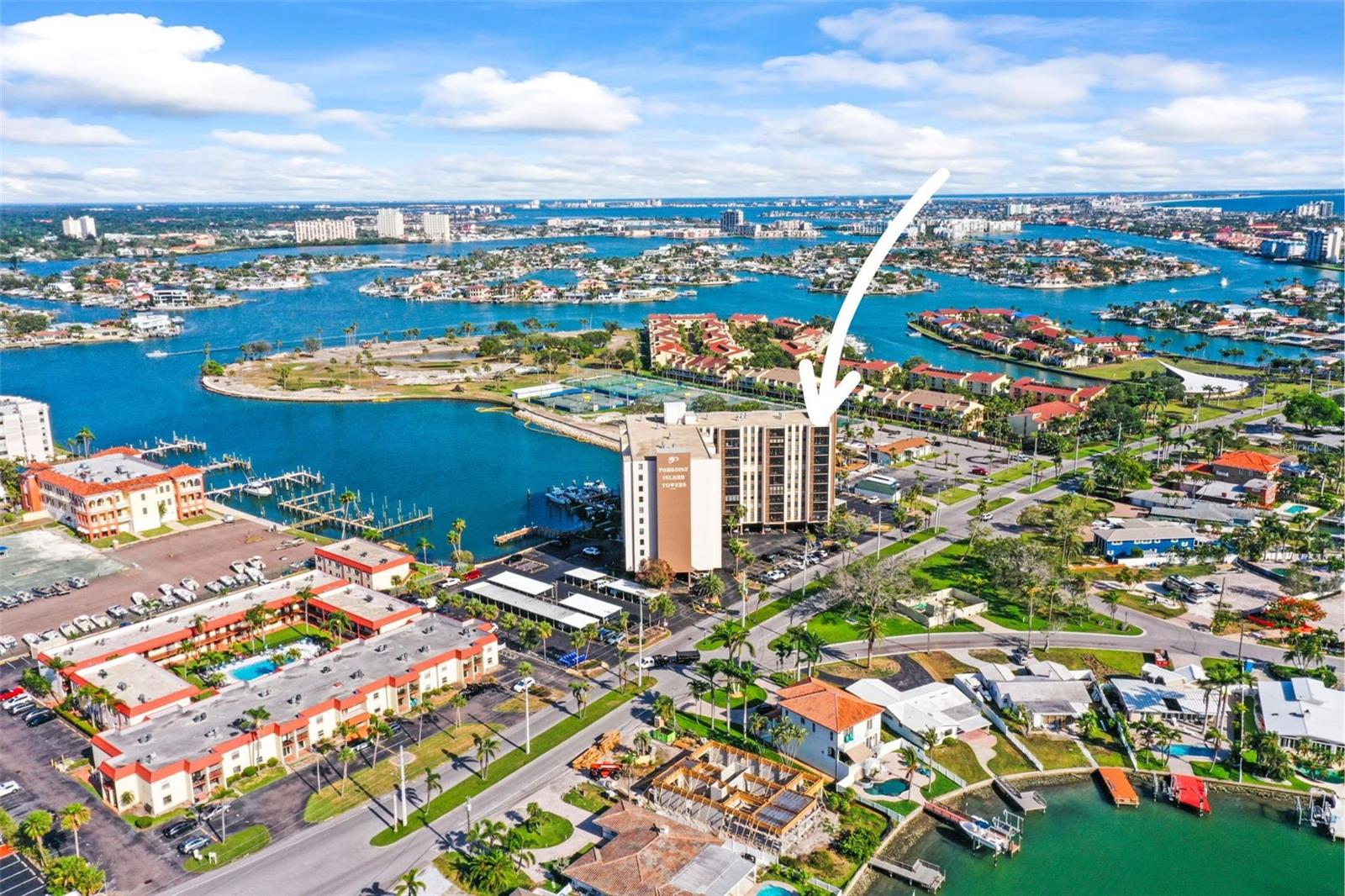 One or more photo(s) has been virtually staged. NEW PRICE! Enjoy SUNSET VIEWS in your slice of paradise with this stunning TOP-FLOOR, CORNER UNIT condo located in the heart of Treasure Island, Florida. Nestled in a well-maintained WATERFRONT community, this immaculate 2-bedroom, 2-bath home offers the perfect blend of comfort, convenience, and coastal charm. Step inside to find beautifully preserved TERRAZZO FLOORS that add timeless elegance and cool comfort throughout the space. Natural light pours in from multiple directions, thanks to the unit’s prime corner location, creating a bright and airy atmosphere. The open living and dining area flows seamlessly, offering ample room for relaxing or entertaining guests. The kitchen is clean and functional, featuring plenty of cabinet space and a layout that is easy to personalize. The spacious bedrooms include generous closet storage and tranquil water views. Both bathrooms have been kept in pristine condition, reflecting the overall care and maintenance seen throughout the entire condo. Enjoy breathtaking sunsets and peaceful mornings from your private top-floor vantage point overlooking the sparkling intracoastal waters. Whether you’re sipping coffee or winding down with a glass of wine, the waterfront views give a daily reminder of what makes Treasure Island so special. This move-in ready home has been lovingly maintained and is truly turnkey — ideal for full-time residents, seasonal snowbirds, or as a smart investment opportunity. With this unbeatable location just minutes from world-famous beaches, dining, shopping, and entertainment, this condo checks all the boxes. Additional perks include assigned covered parking, In-unit Laundry, and a peaceful community atmosphere. Don’t miss your chance to own a piece of Florida’s Gulf Coast in one of the area’s most desirable waterfront neighborhoods. Priced to sell, this condo offers exceptional value and will not last long. Schedule your private showing today and experience coastal living at its finest!