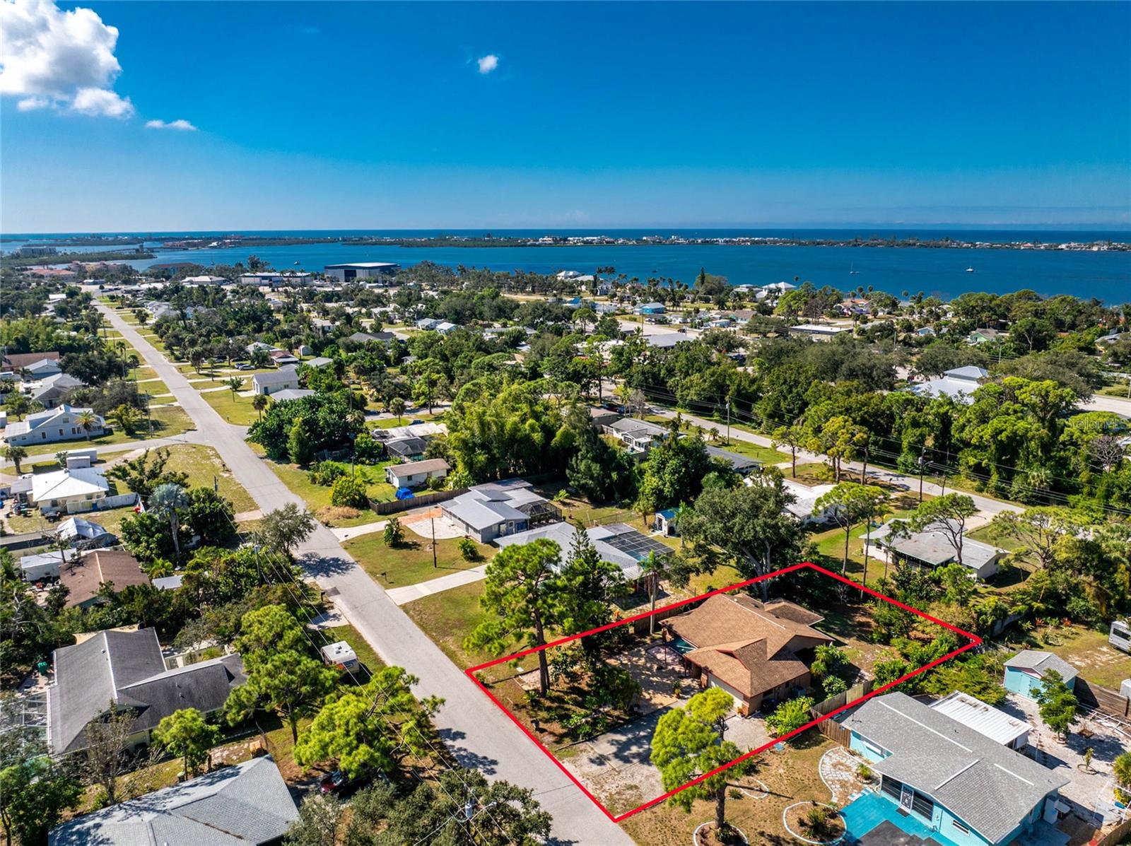 Less than 3 miles to Englewood Beach – what a fantastic location! This charming 2-bedroom + den, 2-bathroom home is situated in the desirable X flood zone and features impact-rated windows, doors, and a garage door for added peace of mind. Set on a spacious lot with mature landscaping, this home offers both privacy and curb appeal with its inviting front porch and brick accents. Inside, tile flooring throughout makes maintenance a breeze. The great room has a vaulted ceiling and a large bay window, creating a bright and airy feel. The kitchen and dining areas are enhanced by vaulted ceilings with skylights, flooding the space with natural light. Stainless steel appliances, granite countertops, a pantry with built-in storage, and double French doors complete the kitchen and dining area. The adjacent den, currently used as a craft and hobby room, offers endless possibilities to suit your needs. The primary suite features a walk-in closet and an ensuite bathroom with a fully tiled step-in shower and a stylish barn-door-style vanity with a quartz countertop. A comfortable guest bedroom and bathroom provide a welcoming space for visitors. The screened-in lanai with a ceiling fan is the perfect spot to relax, enjoy outdoor dining, or unwind with a good book. Located in the heart of Englewood, this home is close to local restaurants, shopping, golf courses, walking and biking trails, and the weekly farmers market on historic Dearborn Street. Don’t miss this opportunity—schedule your showing today!