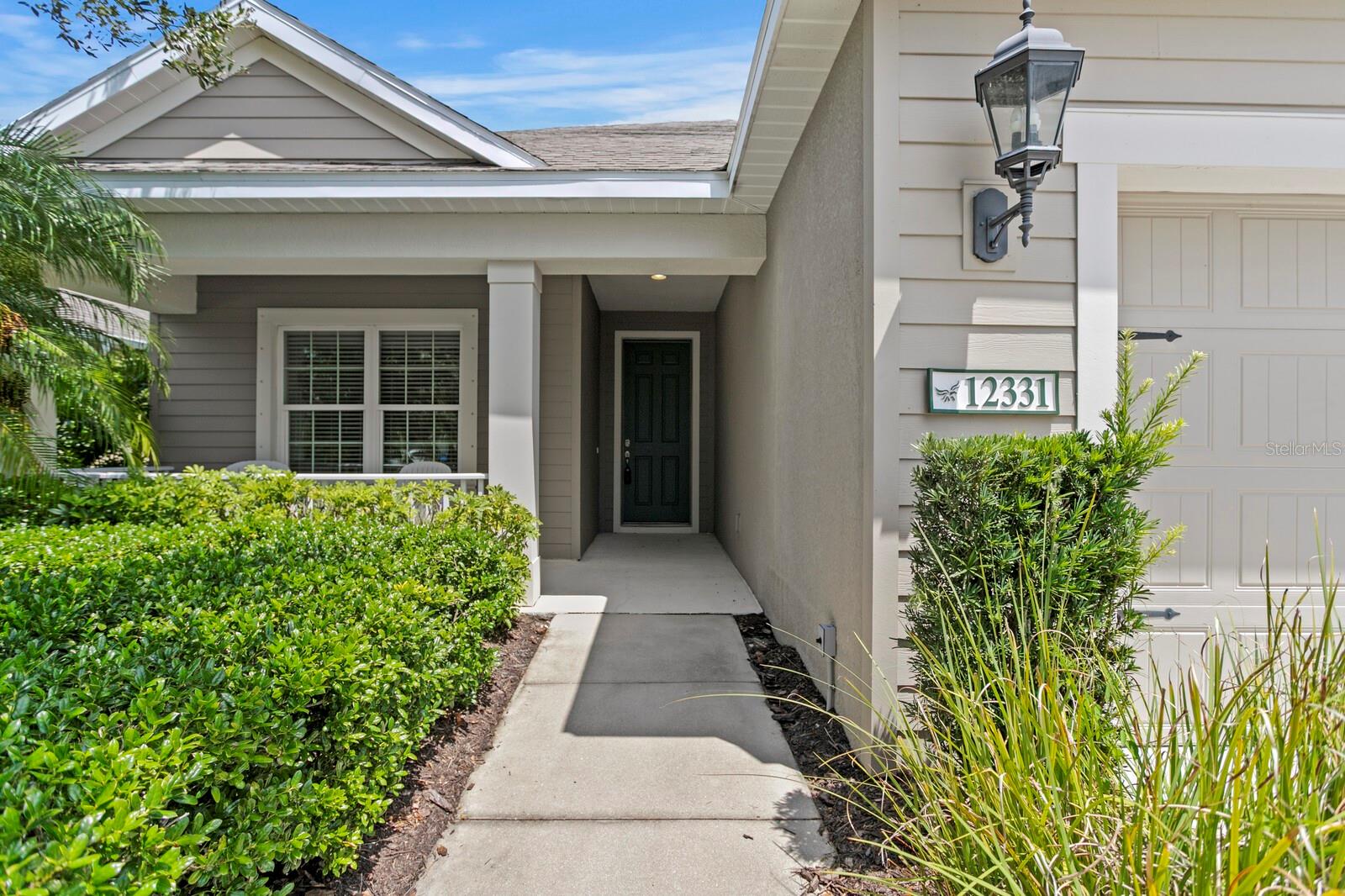 Welcome home to this lovely and rarely available 4-bedroom, 3-bath residence in the gated, maintenance-free community of Eagle Trace. This sought-after Neal Homes Starlight model still shows like a model home with stylish upgrades and meticulous care throughout and offers a bright, open layout perfect for both daily living and entertaining. The gourmet kitchen is a standout feature with gleaming quartz countertops, GE stainless appliances, a custom basketweave tile backsplash, natural gas range, center island with undermount sink, walk-in pantry, and crisp white cabinetry providing generous storage. Large format staggered tile flows through all main living areas, while brand-new 2025 plush carpet enhances all bedrooms. The spacious living room includes floating built-ins and sliding glass doors that open to a screened lanai that has been extended by the current owner to provide ample space for relaxing and entertaining and to enjoy the tranquil lake view—ideal for morning coffee or evening relaxation. The primary suite offers two large walk-in closets and a spa-like bath with dual vanities and a walk-in shower. The 2nd and 3rd bedrooms both have ample closet space and share a lovely bath. The 4th bedroom has an en-suite full bath and is situated separately from the other bedrooms providing privacy and flexibility for guests or multi-generational living. Additional highlights include volume ceilings, recessed lighting, dining area, and a lovely front porch perfect for relaxing afternoons. Eagle Trace residents enjoy a low HOA fee which includes lawn maintenance, no CDD, and access to outstanding amenities including a resort-style pool and spa, cabana, tennis court, playground, dog park, walking/biking trails and picnic area with grills. Conveniently located near White Eagle Plaza, top-rated schools, Lakewood Ranch Main Street, I-75, and just minutes to the UTC Mall, downtown Bradenton, and the white sandy beaches of Anna Maria Island. This is Florida living at its best—modern, move-in ready, and perfectly located!