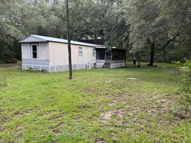 This property offers a two-story garage and an updated mobile home with a newer metal roof with great potential for investors. The property is ideal for flipping, rental, or as an affordable homestead, with a lot of equity potential. The mobile home, a 1988 model with 2 bedrooms and 1 bathroom (672 sq ft), includes a large enclosed porch that could become a third bedroom.
The garage is in great condition, requiring minimal work, the mobile home is move in ready and is extremely cute.. The property sits on 0.4 acres, located on a paved road near Highway 27, offering easy access to Ocala or Gainesville. It features working electricity, a functioning well and septic system, and ample space for a washer and dryer. The area is surrounded by beautiful trees and has a large yard with significant potential for development. There is also a full hookup on the right side of the home for your RV.