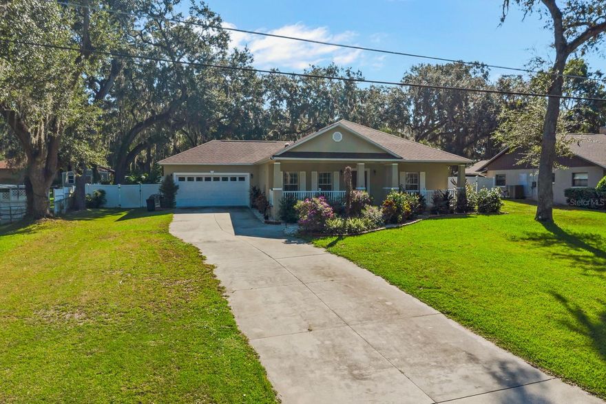 Your Dream Home is here! NO HOA, NO CDD, LOW TAXES… Large Private Fenced Backyard.. Newer Roof Only two years old and Newer AC less than 1 and a Half Years Old, all this on Nearly a Half Acre Lot, Very Large and Long Driveway, Features Stainless-Steal Appliances and Includes Samsung Washer and Dryer.
 This Peaceful, Private, Exclusive Home in the Heart of Fruitland Park, Just Minutes from the Downtown area and Historic Library and Lake Griffin State Park, which boast canoeing, camping, bike trail, walking trail, fishing, very quiet family oriented. The Home is Nestled between the World Famous Villages. And Leesburg. Your New Spacious Home features newer waterproof laminate flooring throughout living areas. The open kitchen has newer granite counter tops and plenty of storage cabinets overlooking the large and spacious Living Room, with natural lighting from the Gorgeous backyard. Bedrooms feature large walk in Closets and wait to you see your Large Newer Gorgeous Lanai with Recently Sealed "BRICK PAVERS“ which will be your perfect spot for entertaining or relaxing for Large Groups of friends and family, while you watch the kids play in their Very Large, completely Fenced in Yard and beautifully landscaped.
  This is a solid home with poured concrete walls, recently updated and upgraded with many of new features including a newer roof (March 2023), front porch railings, irrigation controls, garage openers, garbage disposal, and newer ceiling fans. The backyard is fenced and freshly landscaped front and rear. This beautifully updated Home is Located just minutes from shopping, restaurants, Publix and Walmart and The Villages, this home also offers easy access to the Harris Chain of Lakes and the historic downtowns of Leesburg, Tavares, Eustis, and Mount Dora. You have not only found you peaceful, tranquil home here, but you will encounter a charming neighborhood, Great Neighbors, just a complete Quite, picturesque Home and Neighborhood.