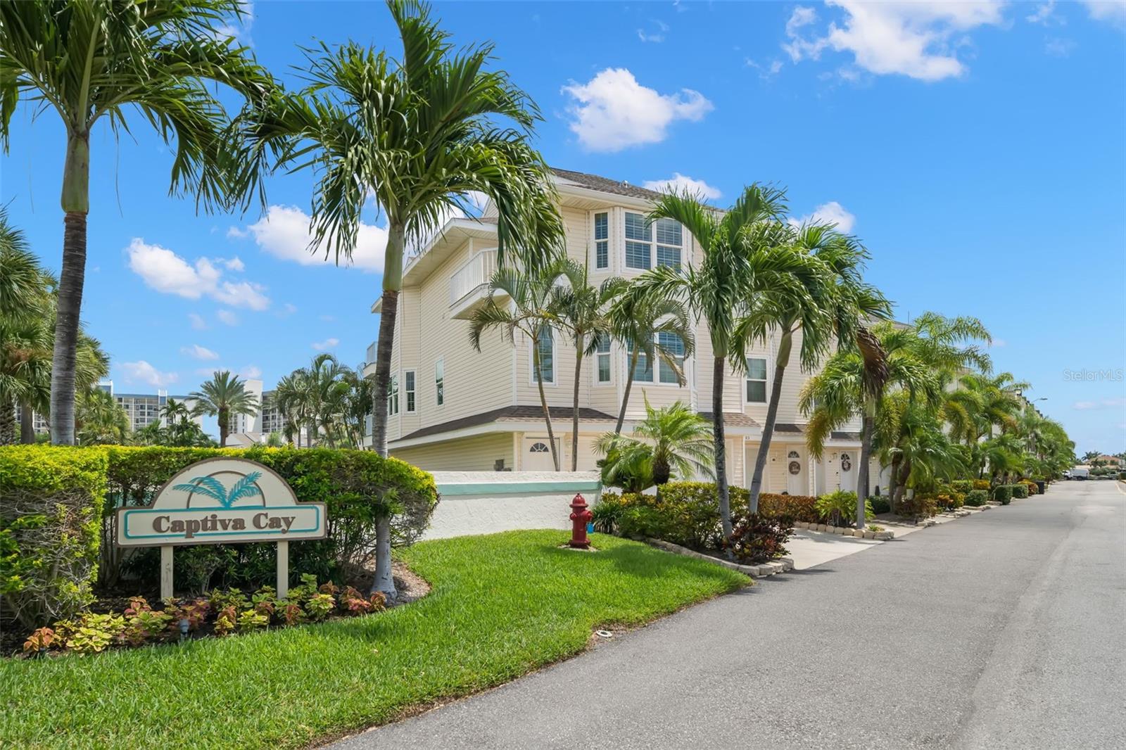 Captiva Cay Townhome with Deeded Boat Slip. This three-bedroom, three-bath residence has a four-car garage and a deeded boat slip! The charming Key West Style exterior includes wraparound porches and plenty of outdoor living spaces to capture those warm salty breezes in the shade. The modern interior updates create a cool and relaxing environment. Access all three floors with your own private elevator. The main living area is on the second floor, with a wide-open floor plan. The living room has a corner fireplace and access to the wrap-around porch for entertaining or al fresco dining. The large dining area is complemented with windows capturing sunset vistas. The bright, modern kitchen has white shaker cabinets with gleaming quartz countertops, breakfast bar and stainless appliances. Plenty of prep and storage space with additional pantry in this beautiful kitchen! The guest suite on the main living level has a peek-a-boo water view of the intracoastal waterway and a beautifully updated bath. The third level guest suite has a private ensuite bath, balcony on the sunset side and a peek-a-boo water view on the sunrise side. The primary suite is enormous with a large walk-in closet, private balcony surrounded by palms and an updated ensuite bath with soaking tub, separate glass enclosed shower, double vanity, water closet and linen storage. Interior updates also include light neutral interior paint and luxury vinyl flooring throughout the living spaces and bedrooms, tile flooring in the bathrooms. Plantation shutters offer privacy and impact glass windows offer energy efficiency and security. The first level is over 1,100 SF and includes a two to four car garage with storage room and another covered patio area. The ground level lanai has a spiral staircase up to the main level porches and a gate that opens toward guest parking, the fitness center and lap pool. Captiva Cay has a gorgeous waterfront Clubhouse with Pool and Spa, Marina and Beach Area. The private deeded boat slip has direct access to the intracoastal waterway. Neighborhood parks offer baseball, tennis, pickleball, dog parks, kayak and paddleboard launch, boat ramp and so much more! This is the sweet spot between Treasure Island and St. Pete Beach! This townhome is fully furnished and has a 4-month minimum rental period.