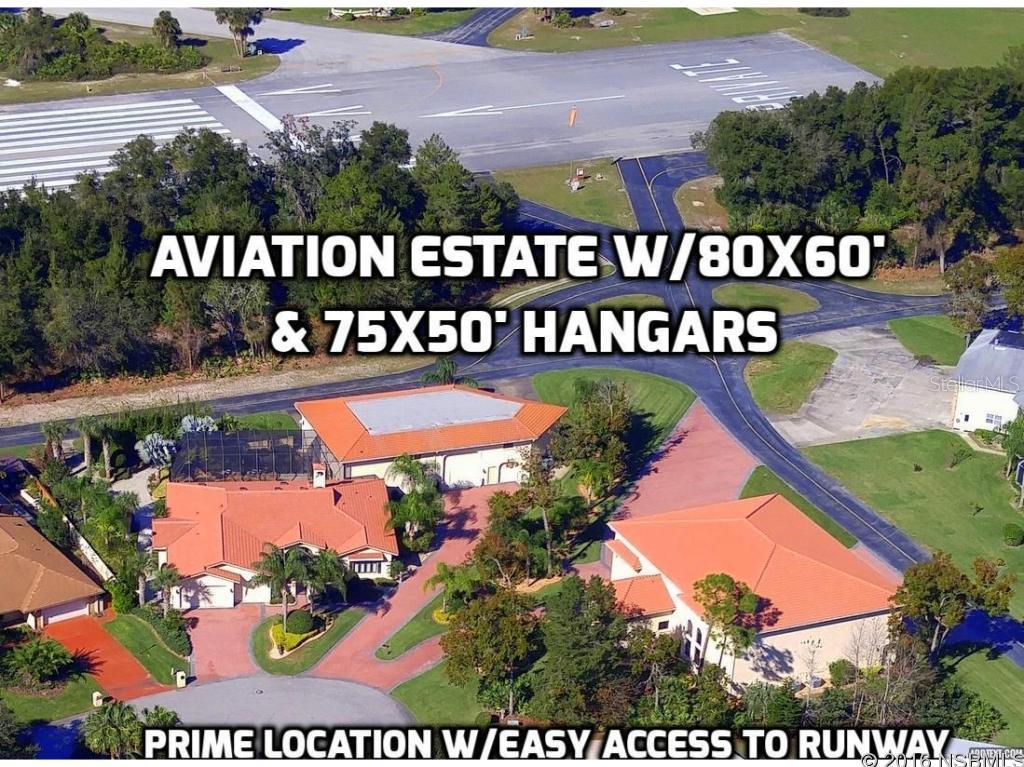 Another Major Reduction! Fantastic Opportunity to purchase a top quality residence at a huge discount below replacement cost! Extraordinary Spruce Creek Fly-In Aviation Estate in America's Premier Fly-In Community which includes 80x60 & 50x75 residential hangars, well suited for General Aviation & Business Aircraft plus a 6 Bedroom 6.5 Bath Casually Elegant Residence, Resort-Style Lanai with Award Winning Saltwater Pool & Spa, Pilotâs Lounge & Media Room. Prime cul-de-sac location offers easy access to the runway. Relax in the Ownerâs Suite with a pool view & feel spoiled with His & Her Separate Bathrooms. The family Chef will enjoy the custom granite kitchen with top-of-the line stainless appliances. Entertain on the spacious Lanai with soothing sounds of the rock waterfall. Enjoy the Great Room with its cozy ventless log fireplace. Plenty of room for family & guests. Your corporate pilot will appreciate the private bedroom in the large hangar, complete with full bath, frig, microwave & big screen TV. Quality is evident in the gorgeous Travertine flooring, Plantation Shutters, Pavered Driveways & Walkways & Tile Roofs as well as the granite counter-topped Summer Kitchen & Butler's Pantry/Laundry Room, 3-Car Garage, 4 hangar doors (including 70x18â Hydroswing & 50x18â bi-fold), two 14â RV Doors, Security Systems, Professional Landscaping, 15-zone Irrigation System with deep well & auto standby 60 KW Generator with 1,000 gallon in-ground propane tank. Furnishings are available. The luxury & quality found in this active private gated community on central Florida's east coast is unmatched. Residents can literally fly home to their private airport community, enjoy golf, tennis or dine at their country club, then drive to the World Famous Daytona Beach & enjoy the sand & surf. This could be great for corporate retreats or large family gatherings! ;Water: City