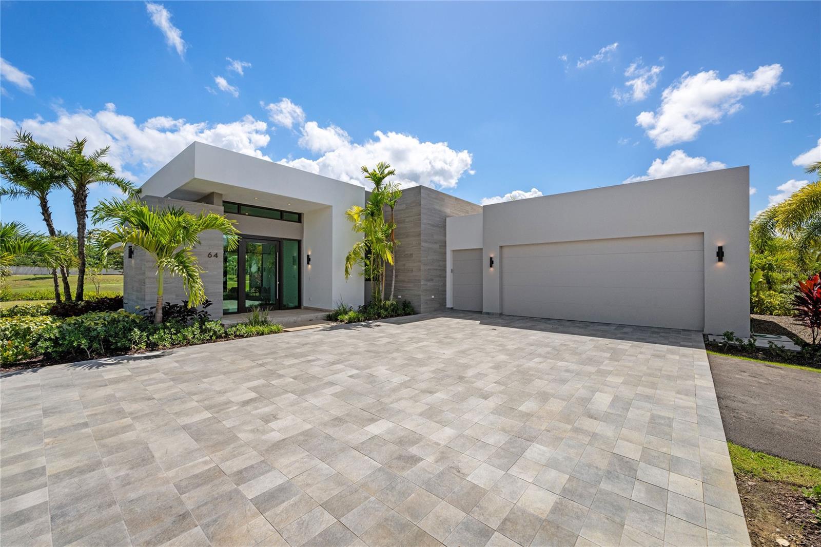 Experience tropical elegance in this exquisite residence nestled within the coveted Isles at Dorado Beach. This beautifully appointed home blends modern sophistication with relaxed Caribbean charm, offering spacious interiors and seamless transitions to outdoor living. Surrounded by lush palms and tranquil water views, the home welcomes you with sleek architectural lines, a neutral color palette, and an inviting sense of warmth and comfort.
The open-concept living space is flooded with natural light, highlighting the home’s refined finishes and upscale details. A gourmet kitchen anchors the main floor, featuring premium appliances, expansive countertops, and custom cabinetry — perfect for both intimate dinners and lively gatherings. Floor-to-ceiling glass doors lead to a private outdoor oasis complete with a covered terrace, and beautifully landscaped gardens designed for year-round enjoyment.
This serene retreat offers the perfect blend of privacy and access to resort-style amenities. Located in one of Dorado’s most exclusive gated communities, residents enjoy access to world-class golf, pristine beaches, and fine dining just moments away. Whether you’re seeking a full-time residence or an upscale getaway, this home delivers luxury, comfort, and the essence of island living.