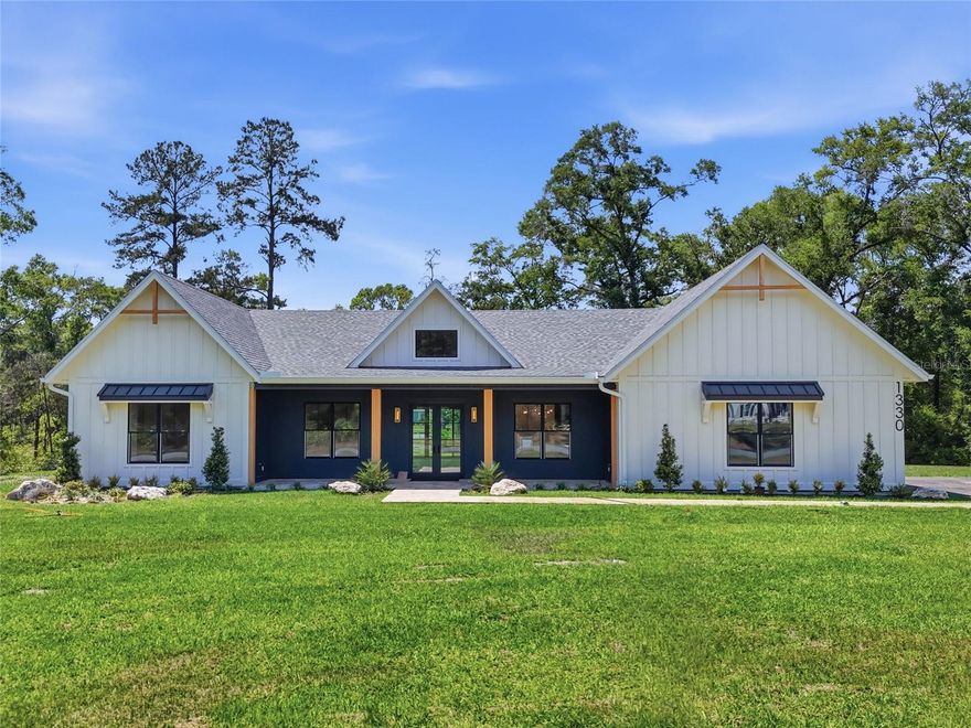 Welcome to a rare opportunity in Lakota 4 Bedroom + Office w/ closet & 3.5 Bath, an exclusive, sold-out gated enclave of just 15 homesites where privacy, nature, and modern convenience come together effortlessly. Ideally located near Jonesville, you are just minutes from shopping, dining, and everyday essentials, yet tucked away on nearly three wooded acres where deer and turkeys are part of your daily backdrop.

This brand-new custom-built residence offers 2,898 square feet of heated and cooled living space, with 4,248 total square feet under roof, and is thoughtfully designed for both everyday ease and elevated entertaining. The curb appeal makes an immediate impression with a travertine walkway, welcoming front porch, cedar-wrapped columns, and a cedar tongue-and-groove ceiling.

Step inside through a Pella front door into a stunning paneled foyer with soaring ceilings and statement lighting. Just off the entry, a flexible room with a closet offers incredible versatility—perfect as a fifth bedroom, office, formal dining space, sitting room, or even a private speakeasy-style retreat. The layout flows effortlessly, with a mudroom located off the side-entry garage and a half bath positioned nearby, ideal for future pool access. A spacious walk-in pantry is conveniently placed for unloading groceries, while a private guest wing or second primary suite features its own walk-in closet and ensuite bath for comfort and privacy.

At the center of the home, the kitchen is designed to impress with upgraded Thermador appliances, custom solid wood cabinetry throughout, and thoughtful design details including reeded glass accents, illuminated cabinetry, and toe-kick lighting. A dedicated beverage nook or wine bar with sink and bar refrigerator adds another layer of functionality and style. The adjacent summer kitchen, complete with a pass-through window, creates a seamless indoor-outdoor living experience perfect for entertaining.

Architectural character continues with vaulted, beamed ceilings and elevated finishes throughout, including champagne gold plumbing fixtures and all Pella windows and doors. Built with performance and efficiency in mind, the home features 2x6 exterior walls, spray foam insulation, two HVAC systems, and two gas water heaters. Additional upgrades include a built-in internal vacuum system with hide-a-hose, prewiring for sound, security, and a centralized media closet, as well as a Generac generator switch already prepped and ready. The garage is equally well-appointed with a utility sink for added convenience.

Outdoor living is just as thoughtfully designed, with a fully equipped summer kitchen including a grill, burner, and refrigerator, creating the perfect setting for year-round gatherings. Lakota offers the flexibility of estate-style living with the ability to accommodate RVs, boats, and barns, subject to design guidelines outlined in the covenants and restrictions.

With underground natural gas, Cox Cable, and AT&T Fiber Optics available, this home delivers modern connectivity while maintaining the peace and privacy of its wooded surroundings.

A one-of-a-kind custom home 14 miles from Shands Hospital, 8.4 miles from North Florida Hospital, 3.9 miles from Town of Tioga, 12 miles from the University of Florida, 7.7 miles to I-75, 3.2 miles to Publix