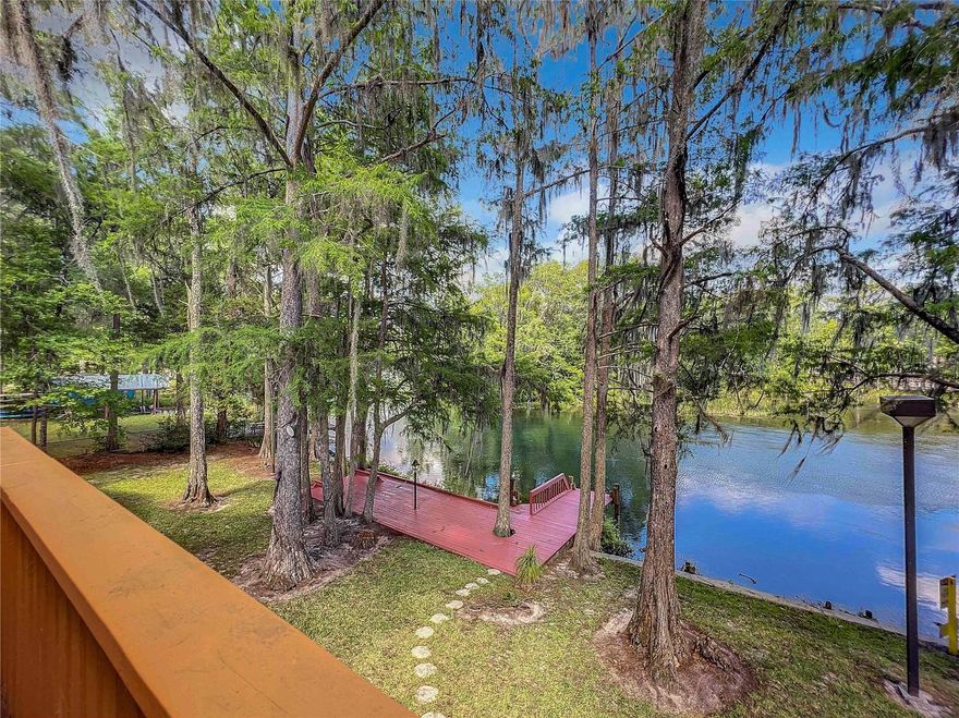 Under contract-accepting backup offers. If you are familiar with the Rainbow River, you are familiar with its majestic glow and the brilliant pops of turquoise that illuminate the sandy spring heads throughout the day.  If you know the Rainbow River, you’ve marveled at its subtle morning haze, the reflections of the old cypress trees on the water, and the seasonal variations of its flora and fauna.  If you are lucky and have had the opportunity to stay on the Rainbow River, you may have been able to catch some of the surrounding morning pinks or afternoon orange glows in the sky, a full moon rise over the tree lines, or the magnificent night sky filled with stars.  If you have yet to learn about the Rainbow River, located in Dunnellon Florida, it is a first-magnitude spring producing about 400-600 million gallons of 72-degree cool water per day, year-round!  This Rainbow River is one of those places, that once you have been there, you really do not want to leave – so don’t, we have the perfect place for you! The Rainbow River Estate boasts a primary residence with 4,668 SF of living space, 220 feet of exceptional river frontage, and a comfortable 2/2 guest bungalow, and it is nestled on 8+ acres! Upon arrival at the estate, you drive through an impressive meadow, often spotting deer and other wildlife. Once you pull up to the home, your eyes are automatically drawn toward the resplendent colors of the Rainbow River and the stunning scenery that surrounds it.  Step onto the dock, take it all in, and visualize the young ones fishing off the dock, launching your boat from the lift, or simply plopping a raft into the water and floating around for a lazy afternoon. Upon entering the home, you’ll see that the oversized screened-in porch is perfect for barbequing and spending time surrounded by family or friends. Inside the home, you will find that its vintage qualities are like a time capsule, perfectly cared for and preserved, and ready to enjoy as is - or ready for you to liven it up with some modern touches! Besides having multiple viewpoints of the Rainbow River from within the home, the best views are from the balconies in the upstairs rooms facing the river - open the French Doors and take in all the beauty surrounding you! With Summer quickly approaching, don’t just dream about that perfect place, get your toys ready, because this is the spot!  Whether you make this a summer, winter, or year-round getaway for you, your loved ones, and friends, or a vacation rental property (it can accommodate 16+ guests!), you will feel continually blessed as you enjoy the natural gifts that surround you and revel in the cool, freshness of the Rainbow River water any time of the year!  Call today to capture one of the very rare Real Estate opportunities in this North Central Florida treasured destination spot!