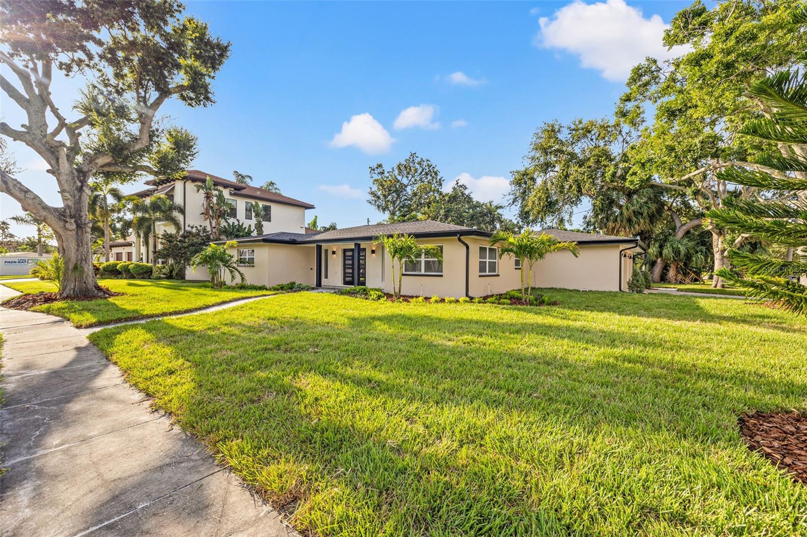 Welcome to 497 Capri, a one-of-a-kind Snell Isle retreat that’s been completely transformed from top to bottom and has never flooded. Every inch of this home has been thoughtfully designed with high-end finishes, custom details, and major wow factor throughout every single room. The heart of the home? This incredible kitchen. A 14-foot quartzite waterfall island anchors the space, surrounded by custom white oak cabinetry, a sleek induction cooktop, pot filler, built-in microwave drawer, and Frigidaire appliances. Wall-to-wall cabinetry allows for extra storage (and style). Soaring vaulted ceilings with exposed beams, recessed lighting, and beautiful millwork make the main living area feel open and bright. And with impact-rated windows, doors, and a new garage door, the upgrades are more than just pretty - they’re practical too and give peace of mind. The primary suite feels like a luxury hotel. It opens straight out to the pool and features a custom walk-in closet and a spa-inspired bathroom that’s seriously next level: an 11.5-foot walk-in shower with 4 shower heads, 8 body jets, LED mirrors, mosaic and accent tile, and a freestanding soaking tub in a European-style wet room. It's a full-on experience. Guests won’t feel left out, the ensuite on the east side has its own oversized walk-in closet, fluted terrazzo accent wall, large shower with custom glass sliders, and a huge niche. There 3rd large bedroom also has access to a stylish hall bath with dual vanities, a tub/shower combo, and more LED mirrors. The laundry/mudroom is just as dialed in, with LG washer/dryer, quartzite counters, beautiful built in bench and tons of extra storage. And then there’s the backyard… custom pavers, new turf, a louvered pergola, outdoor kitchen, resurfaced pool with new tile and equipment, and even a climate-controlled pool bath with dual shower heads. It’s like your own private resort. Major updates include: new roof (2025), HVAC (2024), hot water heater (2025), electrical panel (2025), gutters, soffit, landscaping, irrigation, and fresh sod in the front yard. This one isn’t just move-in ready, it’s unforgettable. Every detail has been done, all that’s left is to move in and enjoy it.