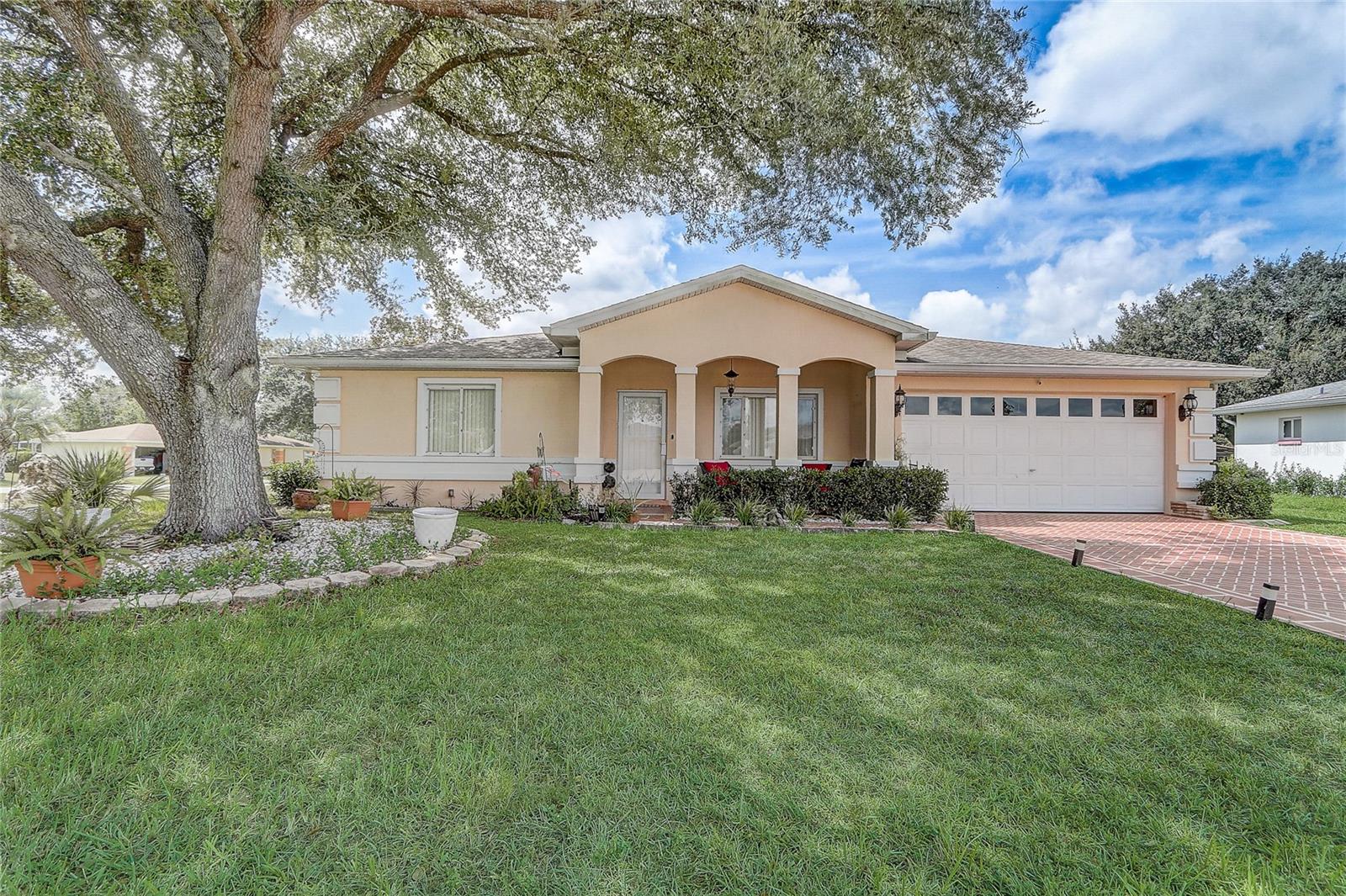 Welcome to this charming 3-bedroom, 2-bathroom home in the sought-after 55+ community of Cherrywood Estates. With 1,855 square feet of living space, this property offers both comfort and functionality. Step up to the beautiful front porch and into a bright, open interior featuring high vaulted ceilings and a formal dining room—perfect for gatherings. The spacious kitchen includes stainless steel appliances, plenty of counter space, and ample cabinetry, flowing seamlessly into the breakfast nook and living room for easy everyday living. The primary suite is a relaxing retreat with tray ceilings, a walk-in closet, and an en suite bath complete with a large vanity, separate shower, and soaking tub. Two additional bedrooms and a second full bath offer flexibility for guests or hobbies. Enjoy year-round relaxation in the enclosed Florida room overlooking the expansive, fenced backyard. The home is connected to public water and sewer, while the irrigation system operates on a private well—adding extra convenience. Major updates include a new roof (2021), A/C (2019), and recently installed water heater. Cherrywood Estates offers a range of amenities including a clubhouse, pool, fitness center, and tennis courts, all just a short distance from shopping centers, grocery stores, Ocala International Airport, and more. This home combines comfort, location, and community—making it a great place to call home.