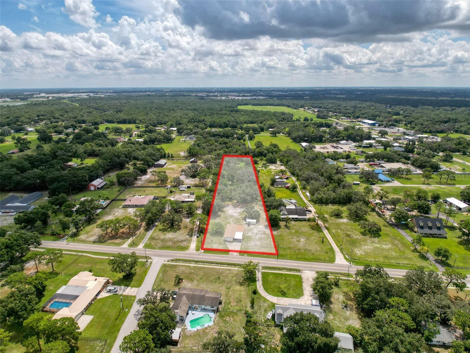 LOCATION, LOCATION, LOCATION! No HOA and a spacious 3.17-acre lot give you room to let your dreams run wild. This concrete block 2 bedroom home features an office and a spacious back room that could easily be converted into a 3rd bedroom with a closet. Key updates include a new roof (2023), HVAC system (approx. 2015) and drain fields replaced in 2010. Cash or conventional financing only. Enjoy country living in Auburndale while still being just minutes from Lakeland and within approximately 40 miles of both Orlando and Tampa, with quick access to I-4, US-92, and the Polk Parkway. Conveniently located near shopping, dining and entertainment—International Market World, one of Polk County’s largest flea markets, is right around the corner. You're also close to top hospitals like Lakeland Regional Health and AdventHealth Heart of Florida, making this a smart choice for both comfort and convenience. Schedule your showing today!!