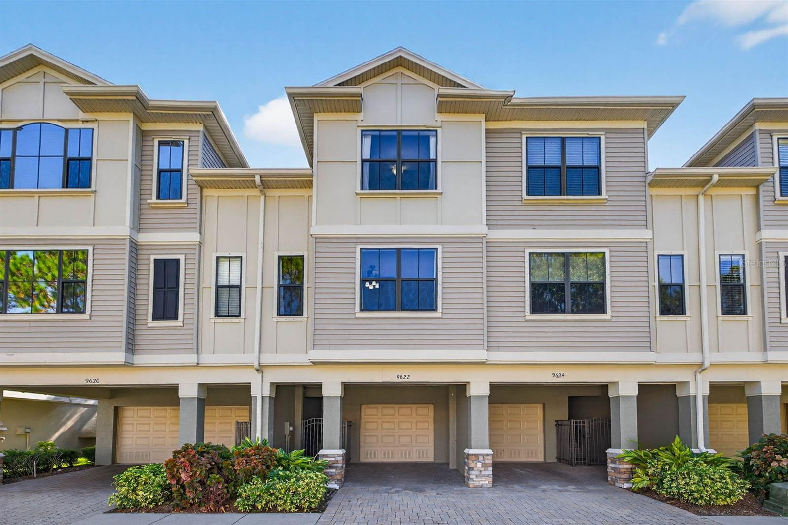 Welcome to the private, gated community of Pelican Pointe that backs up to lush conservation wetlands along Old Tampa Bay. This extremely well-kept community is conveniently located near everything Tampa Bay has to offer. Each unit has its own private gate to the home. Upon entering the townhome, you will immediately notice the beautiful engineered hardwood floors throughout the entire home. There is sleek stair railing on all the stairs as well. On the main living floor, there are two living spaces with the kitchen and dining room in between. The space is great for entertaining. The kitchen features modern cabinets, granite countertops, stainless steel appliances, a large island, and plenty of storage. Off the rear living room is a completely private enclosed patio looking out over the serene pond that is surrounded by cypress trees. This townhome is one of the few in the community where the covered patio is enclosed with its own windows (not just screens) to allow for extra privacy. The rear family room has a stunning feature wall with a built-in electric fireplace surround. Just up a few steps from the kitchen is a perfectly placed guest half bathroom. Up the stairs to the third floor, you'll find a large primary bedroom, bathroom, and walk-in closet. The primary bedroom also overlooks the pond and trees. The primary bathroom has been upgraded in recent years with neutral tile throughout,a shower glass enclosure, newer fixtures, and a large walk-in closet through the bathroom with a custom closet system. The guest bedroom is at the front of the home along with a hall guest bathroom, and a laundry closet. There is a gleaming community pool and facilities solely for the residents of the community. The HOA covers the roof, exterior painting/maintenance, water, sewer, exterior pest control, lawn care, and trash. The tandem garage spans the entire length of the townhome and has additional built-in storage. There is a small paver patio out the back of the garage as well. This townhome is 10-15 minutes to Tampa International Airport, 20 minutes to downtown Tampa, 35-40 minutes to the Gulf beaches, and all the entertainment and restaurants you could ask for.
