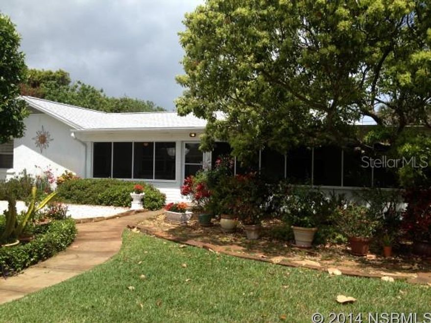 CATCH THE OCEAN BREEZES WHILE SITTING IN YOUR FRONT PORCH 700 FEET FROM THE OCEAN.  4 BEDROOM 2 BATH, THE 2 CAR GARAGE  HAS AN ADDITIONAL  BATHROOM AND LOTS OF STORAGE.   1940 BEACH BUNGALOW FEATURES A 32 FOOT SCREENED IN PORCH, ORIGINAL LARGE CERAMIC TILES, CREATED IN NEW SMYRNA BEACH USED ON PORCH FLOOR, BASE BOARDS, WINDOW SILLS AND BOTH BATHROOM FLOORS.  POSSIBILITY OF SEPARATE MOTHER IN LAW SUITE/ 2 BED ROOM 1 BATH WITH EXTERIOR DOOR.  PERFECT HOUSE FOR FAMILY BUT WITH LOTS OF VERSATILITY FOR GUEST AND MOTHER IN LAW PRIVACY. SEPARATE DINING ROOM, LARGE INSIDE LAUNDRY, OUTSIDE SHOWER, GROUND LEVEL DECK AND LOW MAINTENANCE YARD. UNIQUE FEATURE; ENTIRE EAST SIDE OF EXTERIOR GARAGE WALL HAS A MOSAIC TILE MURAL THAT WAS FEATURED ON HGTV, CREATED BY LOCAL ARTIST BOB HUDGINS. SHORT WALK TO FLAGLER AV TO ENJOY LOCAL RESTAURANTS, SHOPPING AND ENTERTAINMENT. ;Water: City
