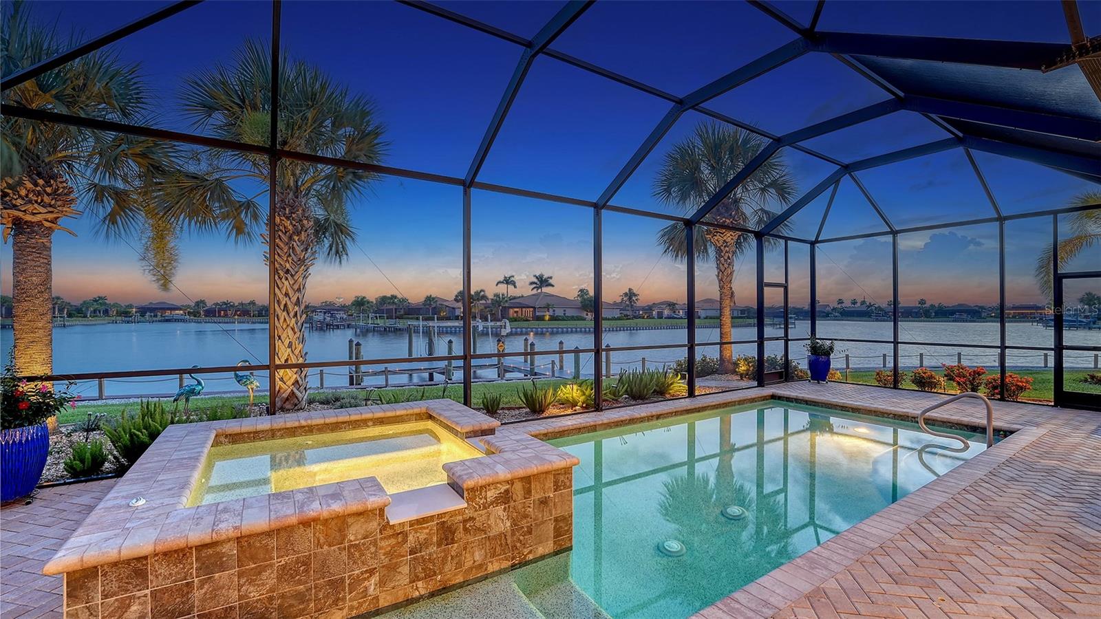 Live where others vacation in this boater’s paradise located in the vibrant, dog-friendly, and young-at-heart gated community of Tidewater Preserve. This 4-bed, 2.5-bath home includes your own private dock with a 10,000 lb lift, power, water, and dock path lights for evening fun under stunning sunsets. With direct access to the Manatee River, you're just minutes from Tampa Bay, sandbars, islands, and over 7 waterfront restaurants—perfect for dock-and-dine adventures. Inside, enjoy breathtaking water views from the kitchen, great room, and owner’s suite. The open-concept layout is ideal for entertaining, featuring a dream kitchen with quartz countertops, a gas cooktop, stainless steel appliances, soft-close wood cabinets, and an oversized farmhouse sink. Designer touches like crown molding, custom wood plantation shutters, shiplap, wainscoting, built-ins, and dimmable lighting add warmth and style throughout. This home is storm-ready with PGT impact glass, blackout Hunter Douglas remote blinds in the master, and a 22.5 KW Generac whole-home generator. Step outside to your heated saltwater pool and spa—an oasis for relaxing or hosting after a day on the water. Tidewater’s resort-style amenities include tennis courts, fitness center, walking trails, kayak launch, dog park, and a full-time social director keeping the community connected and active. Waterfront homes with this level of quality and lifestyle are rare—don’t miss your chance to live the ultimate Florida life.