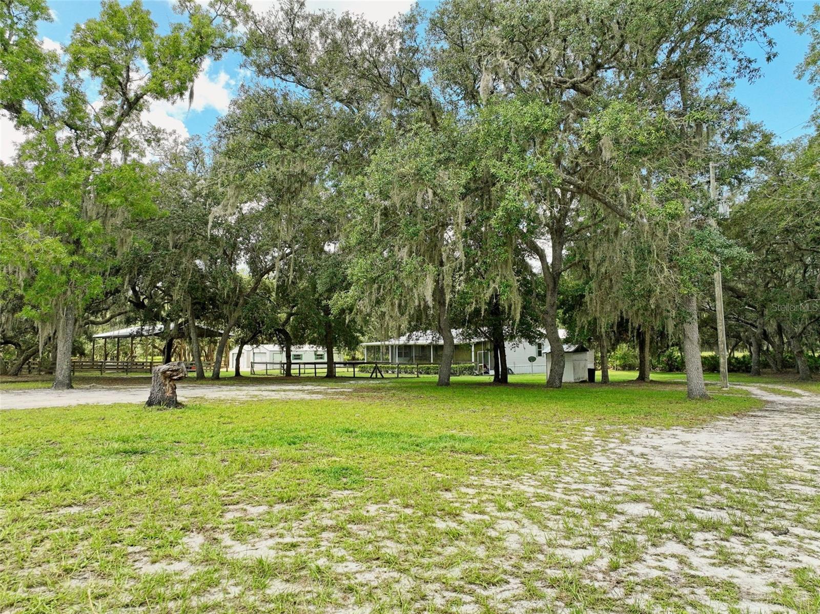 *****Stunning 10-Acre Horse Farm in Marion County, FL: Your Dream Rural Retreat! It seems likely this 10-acreproperty in Marion County, FL, offers a perfect blend of country living and modern convenience, ideal for equestrian enthusiasts and families. It boasts a large grassy paddock with additional areas for your four-legged friends. Two Pole Barns! A lovely, open wooded area backs up to the west side of the home a 27 x14 covered back porch is situated for horses to come up and get a treat while you sit in the shade with your smaller animals. High & Dry the property includes 2 large sheds, RV parking, and is turnkey, offering FHA and VA financing options that enhance its appeal for a wide range of buyers. Main House: Constructed in 2004, this 3-bedroom home includes a spacious 25x22 family room, ideal for gatherings. The back porch is a 27x14 wood deck under the roof with a ramp, and the front porch is screened, measuring 46x12 with a ramp for ease of access, ensuring accessibility and comfort. Detached Mother-in-Law Suite: A3-bedroom unit, with its own garage and RV parking offering flexibility for extended family, guests, or potential rental income, adding significant value to the property. Marion County, located in central Florida and encompassing areas like Ocala, is renowned for its equestrian community. Known as the "Horse Capital of the World," it hosts over 450 horse farms and numerous world-class equestrian events, making it a prime location for horse enthusiasts. The county offers a rural lifestyle with proximity to urban amenities in Ocala, including shopping, dining, and cultural attractions. Schedule your private tour today to explore this dream property and start living the lifestyle you've always dreamed of.