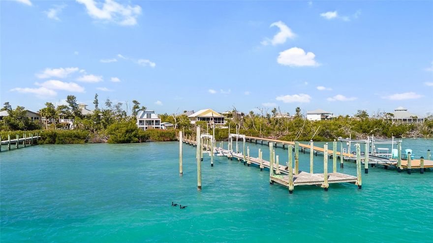 Bayside living at its finest! This beautifully appointed 3-bedroom, 2-bath waterfront home with private dock offers the perfect blend of coastal charm, comfort, and island adventure. Ideally positioned along the bay in an area renowned for exceptional dock fishing and shrimping, this property invites you to experience the very best of island life.

The private dock, complete with a boat lift, lighting, and water, provides effortless access to the surrounding waters—perfect for boating, fishing, or simply enjoying peaceful sunsets over the bay. From the dock, step into a tastefully decorated and spacious home designed with relaxation and entertaining in mind.

The main living level features an open and inviting floor plan that seamlessly connects the great room, kitchen, and breakfast bar, creating an ideal gathering space for family and friends. Just beyond, a large lanai overlooking the bay offers the perfect setting for morning coffee, evening cocktails, or simply taking in the tranquil waterfront views. This level also includes additional seating with a bar area, a guest bath, and a comfortable primary bedroom with its own private bath.

Upstairs, you’ll find two additional bedrooms and another full bath. One of the bedrooms opens through glass doors onto an expansive open sundeck, where you can soak up the warm Gulf breezes and panoramic island skies. The home comfortably sleeps eight, making it ideal as a family retreat or vacation getaway.

Just a short stroll away, deeded beach access leads you to the pristine, uncrowded shoreline where Little Gasparilla Island is famous for its powder-soft sand and extraordinary shelling. Enjoy morning jogs along the surf, long sunset walks, or afternoons spent collecting shells along miles of untouched beach.

Whether your perfect day includes boating, fishing, paddle boarding, swimming, sunbathing, beach combing, or simply unwinding in peaceful seclusion, this home effortlessly accommodates the ever-changing needs of family and friends.

***Little Gasparilla Island is a bridgeless barrier island accessible only by boat***