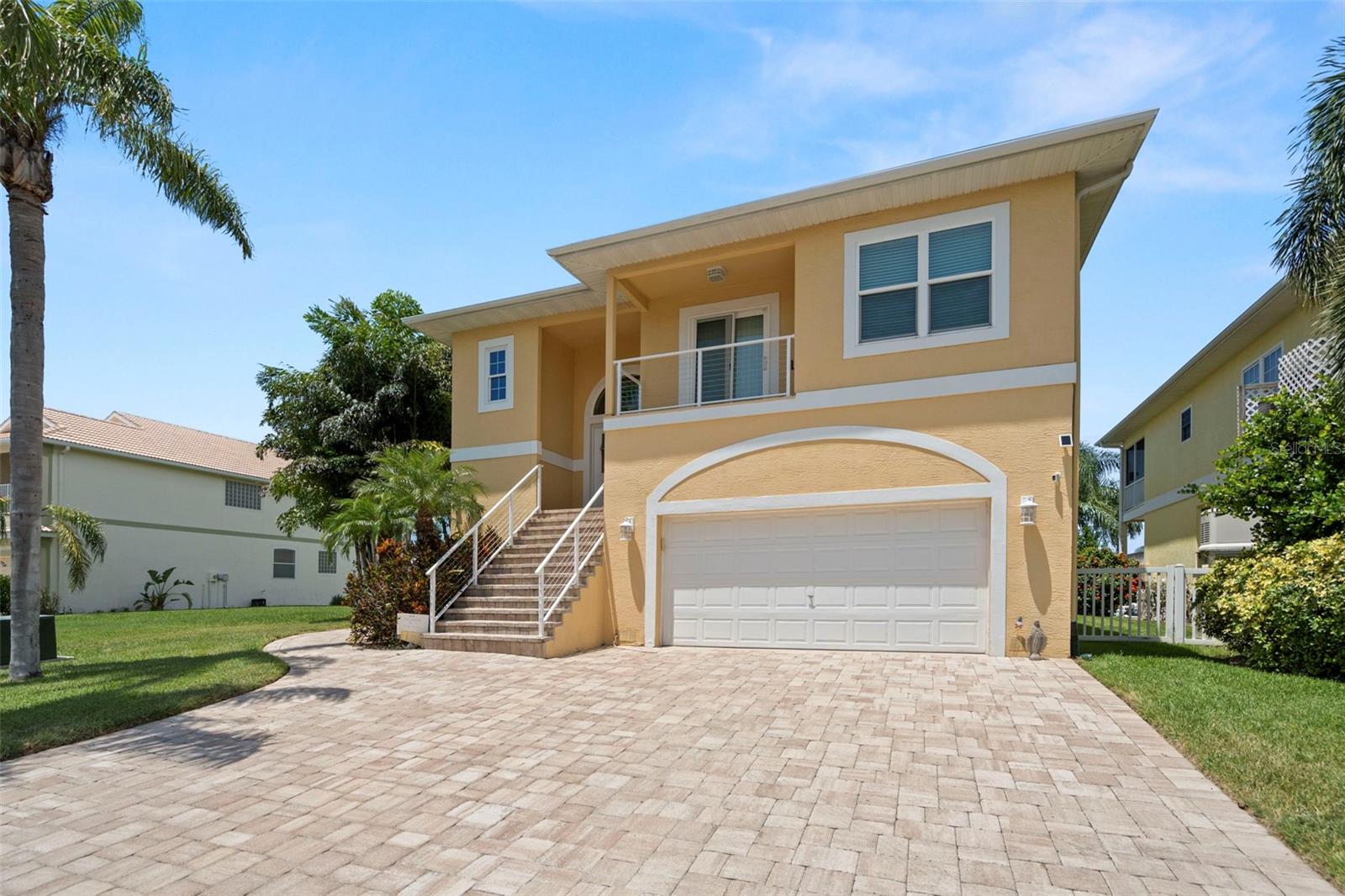 What a gem on the Gulf! This home has been lovingly maintained and features so many terrific extras YOU WILL BE AMAZED! This waterfront pool home has ONE OF THE BEST open views in the community -- the home is situated at the end of a wide canal instead of across from other homes. You will be visited by dolphins, manatee and shore birds on a regular basis! The pool deck is spacious and fenced and is the best place to entertain or enjoy the Florida sunshine. 2 living levels create so many options for the next owner -- the lower level has minimal steps and could be the perfect in-law suite with an open floor plan, complete kitchen, 2 bedrooms and 1 bath with a walk-in shower. That level could also be turned into an income-producing space, or the best temporary home for friends and family when they visit. AND THERE'S AN ELEVATOR!! (inspected and maintained regularly) The top level is the main living space with an open floor plan, split bedrooms (3), and 2 bathrooms, both with walk-in showers. The master is spacious and features large bay windows overlooking the beautiful water and inviting pool -- what a view to wake up to each morning! One of the bedrooms on the front of the home has access to a covered balcony to view sunsets and enjoy the salt air breezes off the Gulf waters. And BOTH living levels feature large, screened lanais overlooking the water and pool areas - double decker open air living! Florida living at its finest! The kitchen upstairs also has a small deck with a propane line for grilling. How convenient! The garage is on the lowest level and has a surprise inside -- a private office space with all the electronics and privacy to conduct business without interruption. The garage also features pulleys for bicycle storage out of the way and other storage options for water toys and tools. The amenities of this home are nearly endless -- so here we go: New roof 2024; top floor HVAC air handler replaced 2024; all new hurricane resistant windows and doors 2019; large Generac generator that will keep the power on for days to the entire property; 500 gallon buried propane tank that provides gas to the generator, grills and fireplace; new 60 gallon water heater installed 2025; new pool equipment/pump/filter installed recently; UV lights have been installed into both HVAC air handlers for eradicating mold/mildew; fiberglass pool resurfaced recently; newer luxury vinyl flooring in smaller living quarters; interior and exterior painted in the last 5 years. On top of the great amenities of this home, the community offers so much to its residents -- there is a large clubhouse with regular events and activities, a community boat ramp, picnic areas, swimming pool, waterfront dockage at the clubhouse, tennis/pickleball courts and access to the only private beach club in the Tampa Bay/Nature Coast area of the Gulf. Only an hour away from 2 airports - TPA and PIE and within minutes of the trendy historic downtown of New Port Richey -- this home is situated in a true hot spot near Tampa Bay, voted one of the best places to live in the USA.