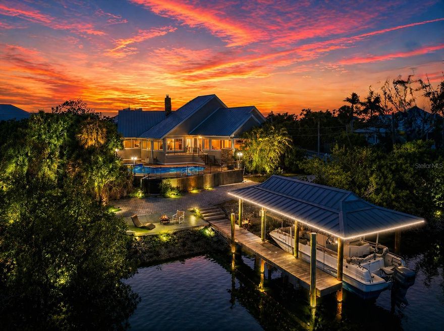 One or more photo(s) has been virtually staged. A rare opportunity to experience elevated bayfront living on Casey Key, this 4,300+ square foot waterfront residence is perfectly positioned on a half-acre lot with 100 feet of frontage along Blackburn Bay, offering breathtaking 180-degree water views and unforgettable sunsets. Designed to capture the beauty of its surroundings, the home features an open-concept layout with soaring vaulted ceilings accented by Epi wood beams, walls of glass, and elegant travertine marble flooring, all seamlessly connecting the interior living spaces to the expansive outdoor setting. The main living areas flow effortlessly to the Epi wood deck, pool, and spill-over spa, creating a true indoor-outdoor lifestyle ideal for both entertaining and everyday enjoyment. The spacious primary suite is located on the main level and offers panoramic bay views, dual walk-in closets, and a luxurious bath with a jetted soaking tub. Upstairs, two bright and airy guest suites each feature walk-in closets and open to a shared balcony, while a fourth bedroom or bonus space provides flexibility for guests, office, or a private retreat. A separate mother-in-law suite adds even more versatility for extended family or visitors. For boating enthusiasts, this property delivers exceptional waterfront access with a rare steel-roofed covered boat slip equipped with a 16,000-pound lift, along with a separate deep-water wet slip for easy navigation to open waters. Just steps across the street, a private deeded easement leads to a wide, pristine Gulf beach, offering the best of both bay and beach living. Additional highlights include an oversized two-car garage, dual driveways with ample parking for up to 10 vehicles, including space for a motorhome, boat, or trailers, and an expansive 3,500+ square feet of climate-controlled lower-level space ideal for storage, workshop, or future possibilities. The home has been extensively improved with over $500,000 in upgrades, including updated systems, pool enhancements, and a durable metal roof. Set along one of Casey Key’s most desirable stretches, this property offers a peaceful island lifestyle with no high-rises, no congestion, and access to resident-owned beaches. Enjoy warm Gulf breezes, tranquil shoreline walks, and golf-cart-friendly access to nearby waterfront dining, tiki bars, boutique shopping, and everyday conveniences. Located just west of Blackburn Point Bridge, the home provides easy access to Sarasota and Venice, top-rated schools, cultural attractions, and world-class amenities, while maintaining the privacy and exclusivity that make Casey Key one of Florida’s most sought-after addresses.