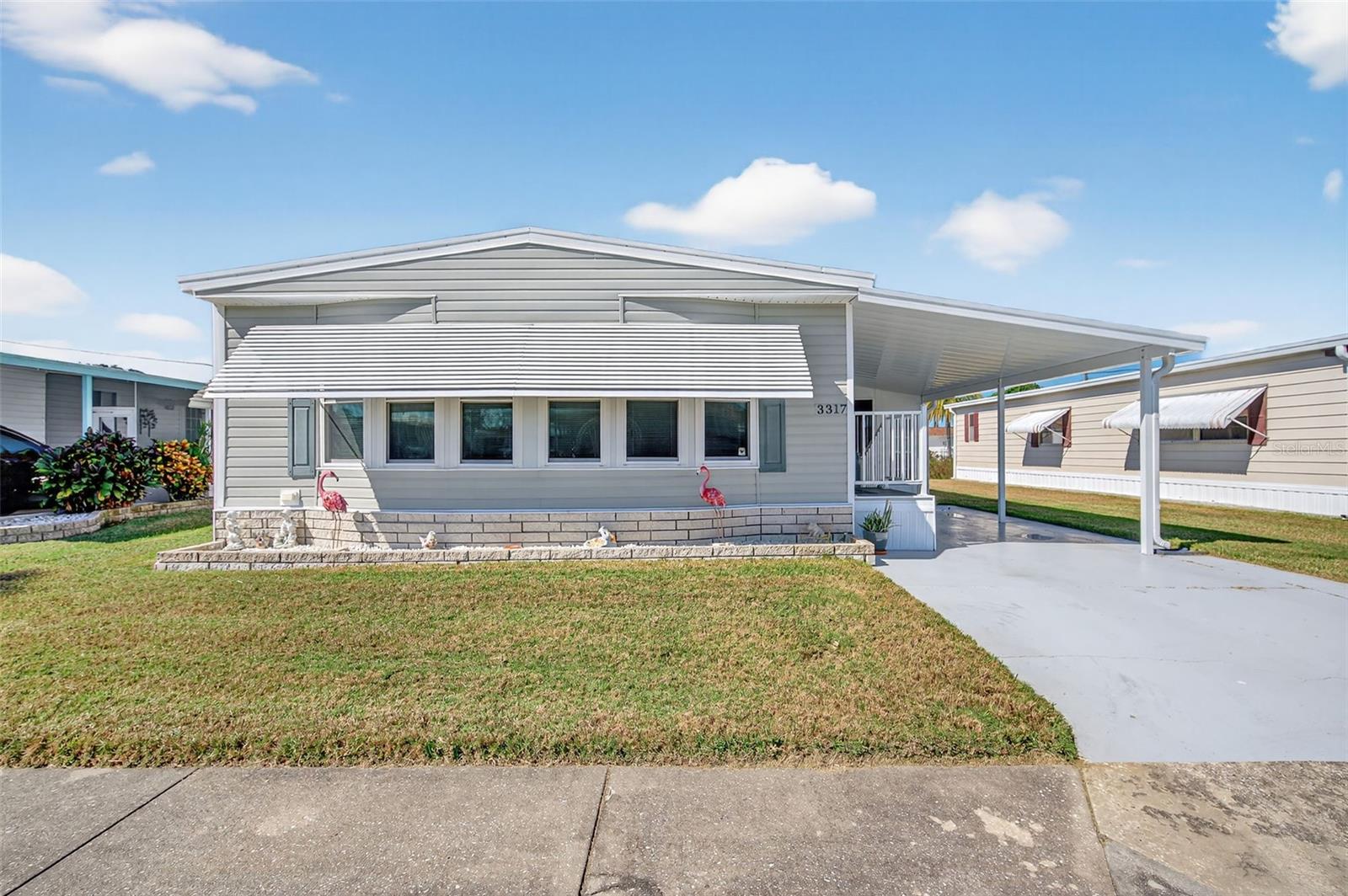 Welcome Home!  This is a lovely and spacious 1344 sq ft Doublewide.  It has been meticulously maintained and ready for the new owners to enjoy! 2 Bed 2 Bath Split Plan offers all the comforts of Home! Relax in the Screened in Lanai with All New Windows for all year round comfort installed in 2022. Plus a Lovely finished porch/family room with air conditioning just off the living room. A kitchen with great space to cook and also a dining area to entertain!  Newer A/C, HWH, Windows for worry free Living! Non Flood Zone X500. This is a Friendly, Active Community, 55+, Heated Pool! Land Owned, AND Fully Furnished/Turnkey!!  Schedule your appointment today!!