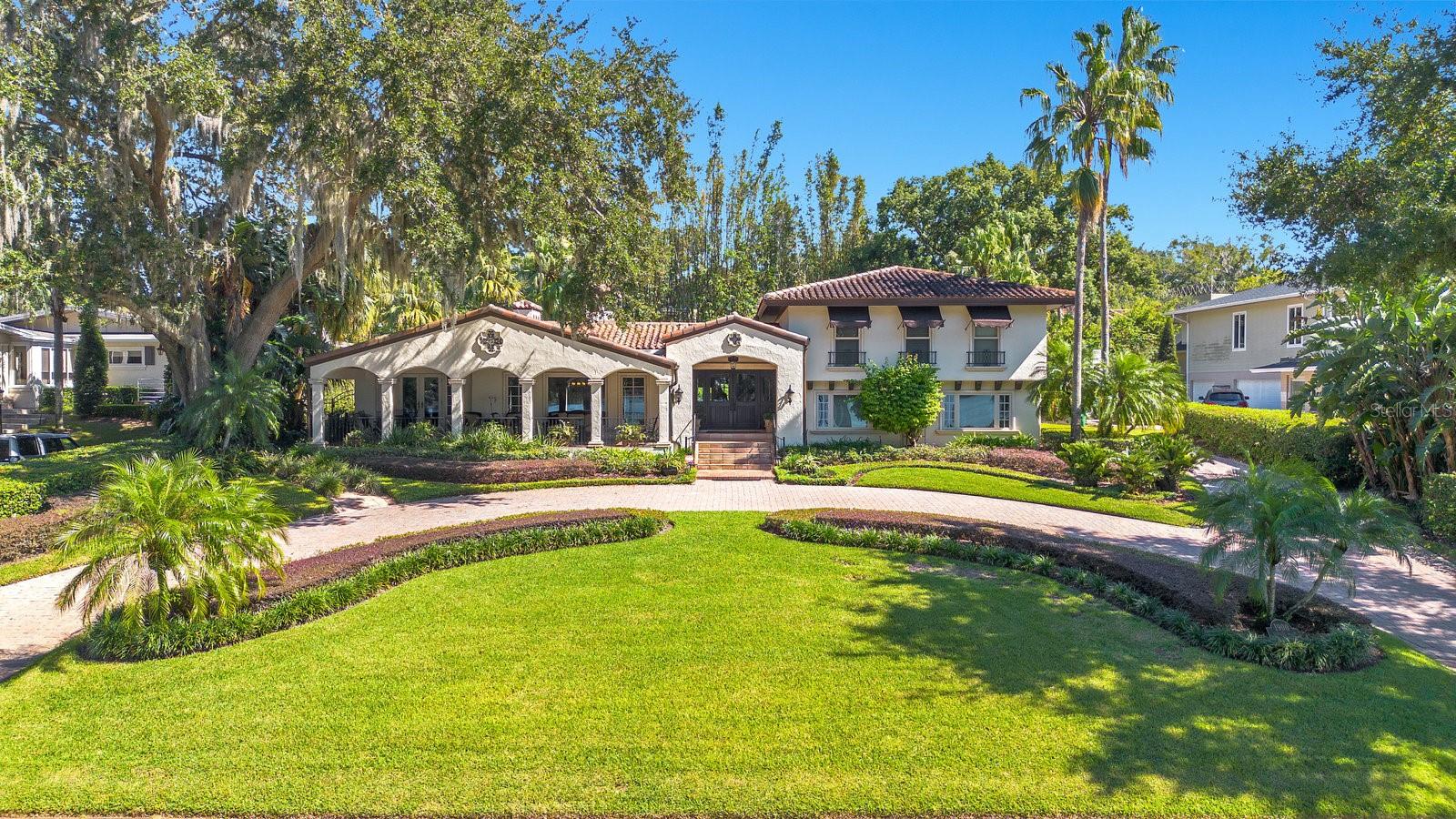 Discover this exquisite lakefront property located in the heart of Winter Park! Nestled on over an acre with more than 125 feet of water frontage, this home offers breathtaking views and absolutely stunning sunsets. As you step through the front door, you’re greeted by captivating lake views that flow from front to back. The spacious foyer leads to a charming living room, complete with a brick wood-burning fireplace. This area seamlessly transitions into the Florida room, an entertainer’s paradise featuring a wet bar, seating area and pool table, with easy access to a full bathroom that is equipped with a steamer shower. Open the French doors to reveal a tranquil outdoor oasis, where mature landscaping ensures privacy for the heated spa, creating a resort-like atmosphere in your own backyard. The heart of the home is a state-of-the-art chef's kitchen, boasting a large island, oversized GE refrigerator, Thermador dual ovens, elegant custom cabinetry, granite countertops, and a cozy breakfast nook. The spacious formal dining and living rooms offer beautiful lake views and lead out to a tranquil front terrace. For those who work from home, a private office on the main floor with a lake view provides an ideal and serene workspace. The large family room is perfect for everyday gatherings and is conveniently located next to a half bath. Upstairs, the primary suite overlooks the lake and features a walk-in closet and ensuite bathroom with a standalone Jacuzzi tub and separate shower. Two additional bedrooms share a full bath, while a generous fourth bedroom serves as a secondary primary suite with its own ensuite and walk-in closet. The property includes a paver circular driveway leading to a side-entry two-car garage. Cross the brick paved road to a sprawling lakefront lawn, leading to a private boat dock with a lift, perfect for enjoying all the water activities. Located on Lake Sue, a private ski lake, this home is just minutes from Park Avenue's shopping and dining, Downtown Orlando, Baldwin Park, playgrounds, parks and excellent public schools. Don’t miss the opportunity to make this stunning lakefront home your own!