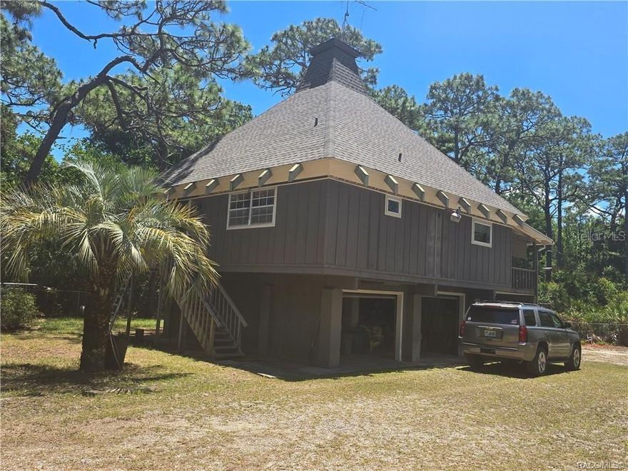 This home has never flooded!! Breathtaking Multi-Level Retreat with 3-Car Dream Workshop & Brand New Roof Fall. in love with this breathtaking, light, and airy multi-level home offering ultimate privacy just minutes from town. Fully secured by a fenced and gated perimeter, this 2-bedroom, 2-bathroom sanctuary features soaring high ceilings and beautiful hardwood flooring. The open-concept design flows seamlessly into a massive, sun-drenched "L"-shaped loft complete with bright skylights. Upgrades include a brand-new roof.The crown jewel of the property is a massive, air-conditioned 34x26 detached workshop with room for 3+ vehicles, plus an additional 15x10 tool room. Built for heavy-duty projects, the shop features solid concrete flooring with built-in washouts, dedicated electric, water, and integrated air lines.
