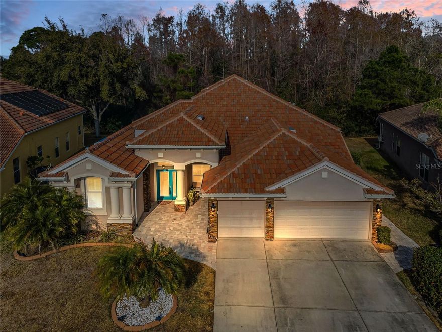 POOL HOME...Set behind the gates of upscale Waters Edge, 9144 Topneck St in New Port Richey delivers the Florida lifestyle buyers come for: a true pool home with flexible living space, a 3-car garage, and meaningful updates already done, including a new tile roof in 2024 and new windows in 2019. From the moment you step inside, the home is designed to make everyday life feel easier, with room to spread out, gather, and still enjoy privacy when you want it.This home offers 4 bedrooms plus a versatile upstairs bonus room that can serve as a possible 5th bedroom or office, along with 3.5 baths. The kitchen is set up for both busy mornings and weekend hosting, featuring stainless steel appliances and granite countertops for a clean, polished workspace. The primary suite is a true retreat, highlighted by two large walk-in closets with built-ins and an en suite bath with dual vanities. Each of the additional bedrooms is notably spacious, giving everyone more breathing room for sleep, study, or hobbies without feeling squeezed. Upstairs, the oversized bonus room adds the kind of flexibility that elevates day-to-day living. With a half bath, a closet, and a huge walk-in closet or storage area, it easily adapts to what you need now and later, from a media room or home office to guest space or a dedicated workout zone. It is an ideal solution for buyers who want separation between main living areas and a secondary space for work, play, or quiet time. Step outside and the home truly shines, with a beautiful INGROUND POOL AND SPA...pool area that invites you to unwind after a long day and makes entertaining feel effortless. Whether it is weekend cookouts, casual evenings under the stars, or a laid-back afternoon by the water, the outdoor space is set up for the relaxed rhythm that makes Florida living so appealing. A 3-car garage adds everyday convenience, with extra Room for vehicles, gear, and storage that keeps the home feeling organized. Waters Edge is known for resort-style amenities that expand your lifestyle beyond your front door, including a large pool, splash pad, fitness center, clubhouse, basketball courts, a fishing pier, two playgrounds, and more. HOA fees include extended basic cable, internet, reclaimed water for irrigation, trash pickup, and security, offering built-in convenience and simplified monthly planning. If you have been waiting for a pool home with space, flexibility, and community amenities that support an active, comfortable lifestyle, Schedule your private showing and experience 9144 Topneck St for yourself!