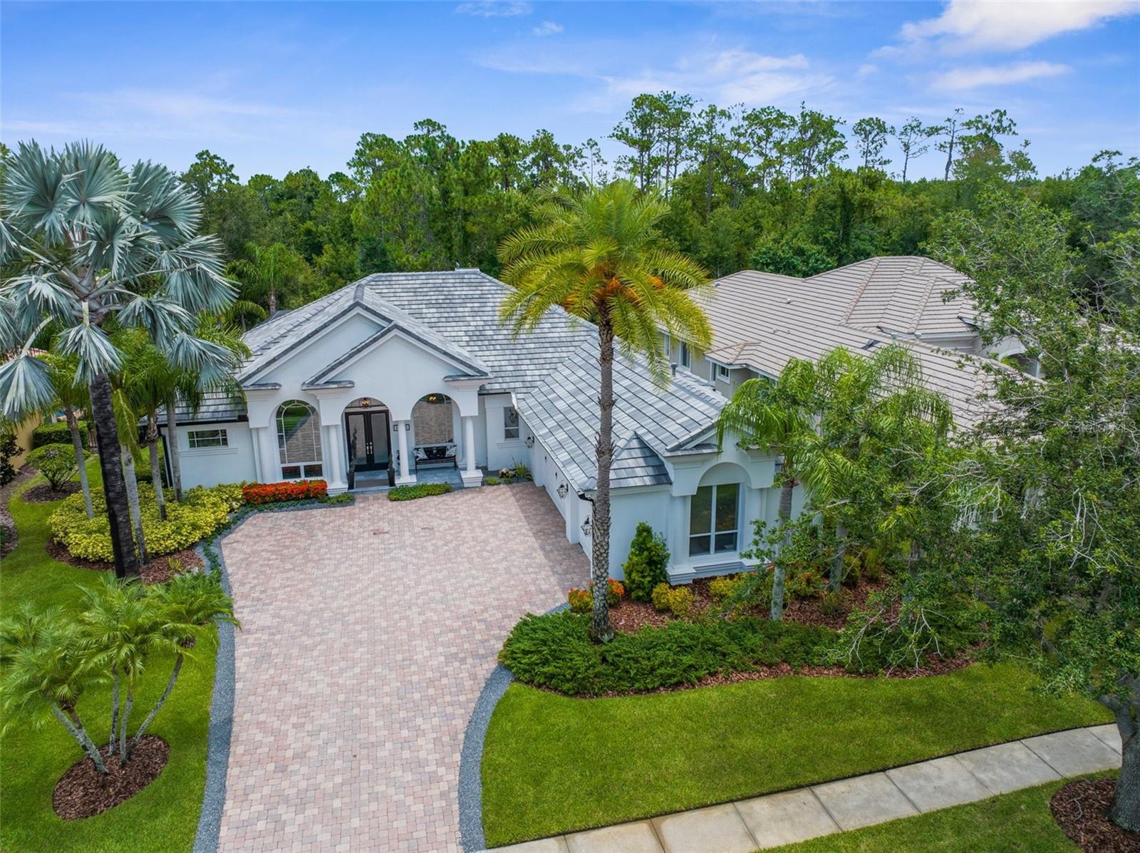 Step into modern luxury in one of Tampa’s most sought-after gated communities, Waterchase. This updated, move-in ready home offers a perfect blend of sophistication, comfort, and warmth. From the moment you arrive, the sleek, contemporary exterior sets the tone for what awaits inside: a light-filled, bright, and airy interior with thoughtfully curated finishes throughout.
The interior showcases soaring 14-foot ceilings, custom tile flooring, designer lighting, and extensive built-ins. The open-concept layout flows effortlessly through expansive living areas, offering both elegance and functionality. At the heart of the home is a chef’s dream kitchen featuring top-of-the-line appliances, custom cabinetry, quartz countertops, a beverage chiller, and a large island with a prep sink, ideal for entertaining.
The well-designed split floor plan includes four spacious bedrooms, a dedicated office, and a versatile bonus room. The luxurious primary suite offers direct access to the pool and tranquil water views, a walk-in closet with custom built-ins, and a spa-inspired bath with a stand-alone tub and oversized walk-in shower.
Step outside into your private oasis — one of the largest pools in the community, an outdoor kitchen, and peaceful water views create the perfect setting for relaxing or entertaining. Other recent updates include a new roof installed in 2024, and dual-zone AC systems added in 2022. Other features include a whole-house generator and a full-home water filtration system.
Located in the resort-style Waterchase community, residents enjoy unmatched amenities including pickleball, tennis, and basketball courts, a playground, and a community pool with an exhilarating waterslide. Waterchase is also known for its welcoming atmosphere, top-rated schools, and convenient access to shopping, dining, and major highways.
This home is truly a showstopper — combining privacy, comfort, and high-end living in every square foot. Don’t miss this rare opportunity to own a turnkey, modern masterpiece in one of Tampa’s premier neighborhoods. Schedule your private tour today!