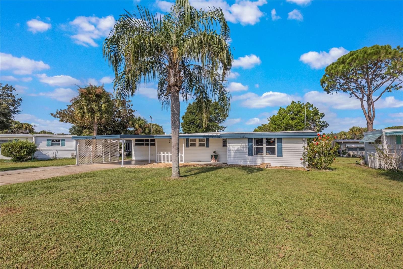 Furniture included? Yes! This home conveys with select pieces. Located in a friendly and welcoming 55+ community, this charming mobile home offers 1,898 sq. ft. of versatile living space. The home features two bedrooms and one bath, plus additional living areas created by the owner through enclosing a lanai creating an additional room and bath converting the former pool space into an additional office/den and a garage with attached storage. The spacious lot and inviting curb appeal make this home warm and welcoming. Residents enjoy access to a sparkling pool and clubhouse and access to the community's private boat ramp which offers direct access to Lake Harris for boating and fishing?all these amenities are perfect for relaxation, social gatherings, and fun times with friends and neighbors. Conveniently close to shopping, dining, activities, medical centers, and the hospital, this home combines comfort, convenience, and community in one ideal location.