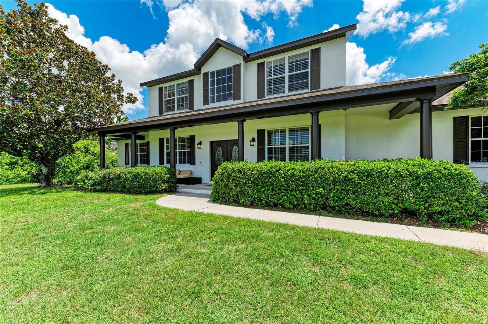 This updated 2 story 4/3 Cahill home is located on one of the largest lots in the Preserve at Panther Ridge. This spacious property offers a relaxing country style porch with a designer custom door and a large backyard with a porch. As you enter the home, you will find an office with beautiful French doors on your left and a private dining room on your right. The large family room has vaulted ceiling and sliders that open to the backyard. The family room is perfect for entertaining guests or enjoying family time. The kitchen was completely renovated with quartz counters, stainless steel appliances, and wood cabinets. The kitchen has an open floor plan that connects to an eat-in-kitchen with a window overlooking the backyard. The kitchen is modern and functional, with plenty of storage and counter space. The master bedroom is located downstairs and features a beautiful French door to the outside. The master bathroom has been totally remodeled with a free-standing soaking tub, dual sinks, quartz counters and a walk-in shower. The master suite is elegant and comfortable, with a large closet and natural light. The second bedroom downstairs is as large as a master bedroom and can be used as a dual master bedroom, bonus room or game room. Upstairs you will find an open loft and sitting area, 2 bedrooms and a full bathroom. The loft can be used as a study or play area. The bedrooms are cozy and bright, with ceiling fans and plantation shutters. The Preserve at Panther Ridge is a vibrant community with “A” rated schools, walking trails, lakes, tennis court, basketball court and playgrounds. The neighborhood is conveniently located close to the UTC mall, Lakewood Ranch Main Street, numerous fine restaurants, and Florida’s best beaches. 50 minutes from Tampa Airport and 30 minutes from Sarasota Airport. This property is perfect for anyone looking for a peaceful and convenient place to call home. NO CDD and LOW HOA. This home is also available for sale.