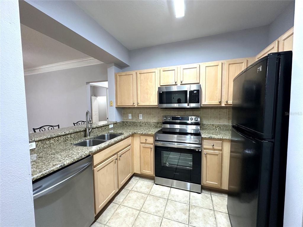 Photo of 12843 Madison Pointe Circle E #201, Orlando, FL 32821 (MLS # O6350594)