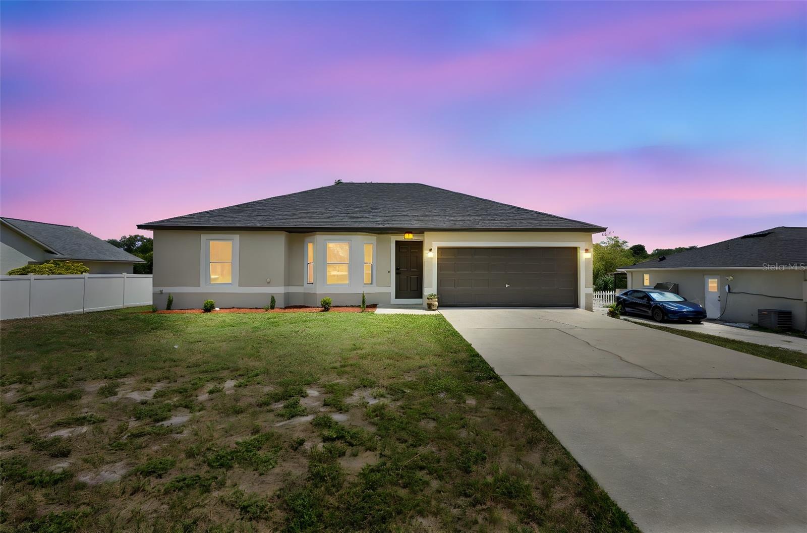 Fully remodeled 3-bedroom, 2-bath home in Deltona offering a modern aesthetic and worry-free living. Featuring a brand-new roof, fresh paint inside and out, and luxury vinyl plank flooring throughout. The open-concept layout boasts vaulted ceilings and abundant natural light. The kitchen is equipped with quartz countertops, shaker cabinets, and stainless steel appliances. Both bathrooms have been completely updated with custom tile and modern vanities. Enjoy indoor-outdoor living with sliding glass doors leading to a brand-new wood deck overlooking a peaceful, private backyard with no rear neighbors. The home also includes a spacious two-car garage and a wide driveway for extra parking. Located near I-4, schools, shopping, and parks. No HOA and move-in ready—this home offers the perfect combination of style, comfort, and convenience. Schedule your tour today!