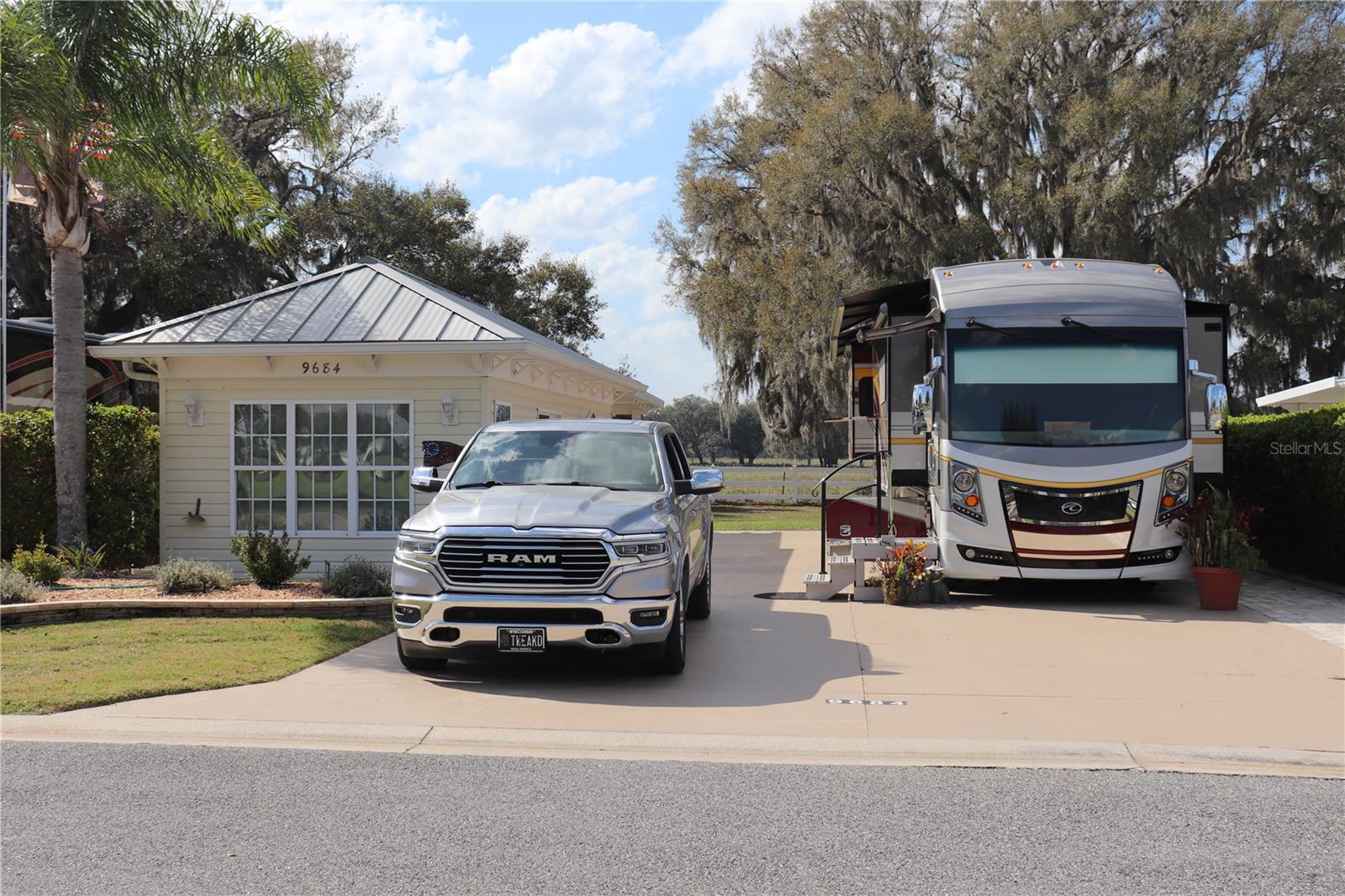 Discover one of the most breathtaking lots in Florida Grande. This 5,076 sq. ft. back-in property
offers unparalleled views with majestic southern live oak trees lining the back—truly nothing
like it. The 26’x76’ concrete pad is equipped with full hookups, making it ready for your RV.
Included on the lot is a beautifully furnished 384 sq. ft. Grande Suite, designed for comfort and
style. Inside, you'll find luxury vinyl plank flooring, upgraded cabinetry, and a well-equipped
kitchenette with a microwave. The living area includes a couch, TV, chair, and a foldable dining
table, all included—move-in ready.
The full bath features a tiled shower with glass doors, adding a touch of elegance. At the back, a
laundry area comes with a full-size refrigerator and full-size washer and dryer, plus extra built-in
storage for your convenience. With crown molding, recessed lighting, and impeccable
craftsmanship, this suite is a true standout. But the real showstopper is the view—sit back and
enjoy the serene beauty of Florida Grande from your private retreat.
Florida Grande is a premier Class A & Super C motorcoach resort offering luxury RV living in a
peaceful, nature-filled setting. Residents enjoy top-tier amenities, including a 20,000 sq. ft.
clubhouse, heated pool, fitness center, pickleball courts, a dog park, and a packed social
calendar. The resort is gated for security and designed for those seeking an upscale RV lifestyle.
Conveniently located just an hour from Tampa, Orlando, and Ocala, and only 30 minutes from
The Villages.
HOA dues are $332 per month and include water, sewer, trash, irrigation, mowing, and all resort
amenities.
Don’t miss this rare opportunity to own this rare gem. Schedule your private
showing today.