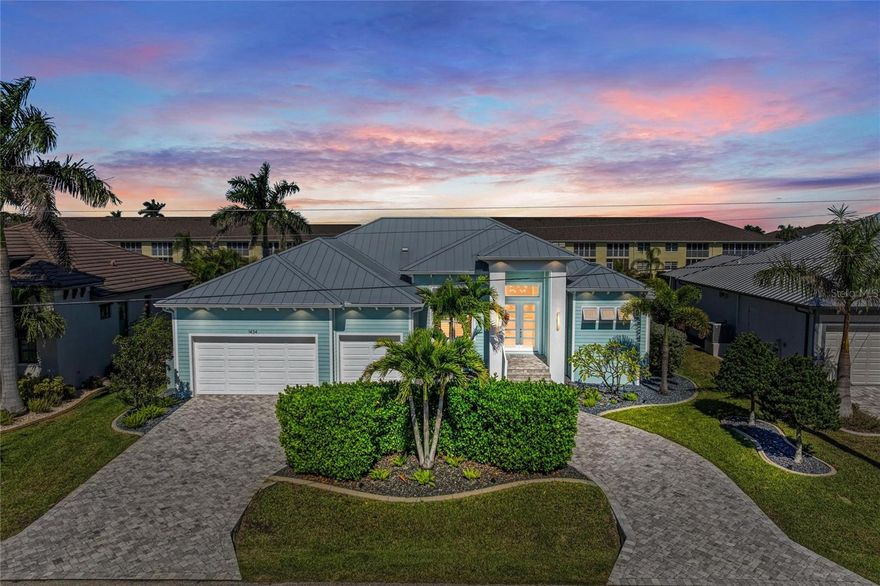Live Your Southwest Florida Dream Now – No Waiting to Build!

Why wait years to build when you can own this exceptional 2019 custom-built Charlotte Harbor Construction home on a fast-access, deep sailboat canal in Punta Gorda Isles today! Designed for those who appreciate quality craftsmanship and modern coastal living, this 4-bedroom + den, 4-bathroom residence delivers the perfect blend of style, function, and Florida luxury.

From the curb, the home makes a striking impression with its Key West-inspired architecture, featuring Bahama shutters, decorative corbels, upgraded landscaping, and a paver circular driveway leading to a spacious 3-car garage.

Step inside the grand double doors to discover an open-concept floor plan with soaring double tray ceilings, zero-corner sliding glass doors, and panoramic water and pool views that instantly set the tone for elegant coastal living. The great room flows seamlessly into the gourmet kitchen, complete with custom cabinetry, quartz counters, a large island with breakfast bar, and premium appliances—ideal for entertaining or quiet mornings at home.

The primary suite is a private retreat overlooking the pool and canal, offering direct lanai access, dual walk-in closets with custom organizers, and a spa-inspired bath with glass-enclosed shower and dual vanities. Three additional guest suites—each with access to their own baths, including one with pool access—ensure privacy and comfort for family and friends. A dedicated den/office adds flexible space for work or relaxation.

Outdoors, the 2021 addition of a heated saltwater pool and spa with panoramic screen enclosure creates a tropical oasis overlooking the water. Plumbing and electric are ready for a future outdoor kitchen, and the 10,000 lb boat lift and extended concrete dock provide direct access to Charlotte Harbor and the Gulf through Buckley’s Pass—with no bridges to navigate!

Tech-savvy buyers will love the smart home automation, remote-controlled lighting and shades, 7.1 surround sound, 4K surveillance system, EV wall charger, and integrated WiFi network with Cat6 connections throughout. Energy efficiency is built in with spray foam insulation and all impact-rated windows and doors.

This home truly has it all—meticulously maintained, beautifully designed, and ready to enjoy immediately. Skip the construction delays and step right into your waterfront Punta Gorda Isles paradise.BE SURE TO CLICK THE FULL VIRTUAL TOUR LINKS FOR DETAILS!