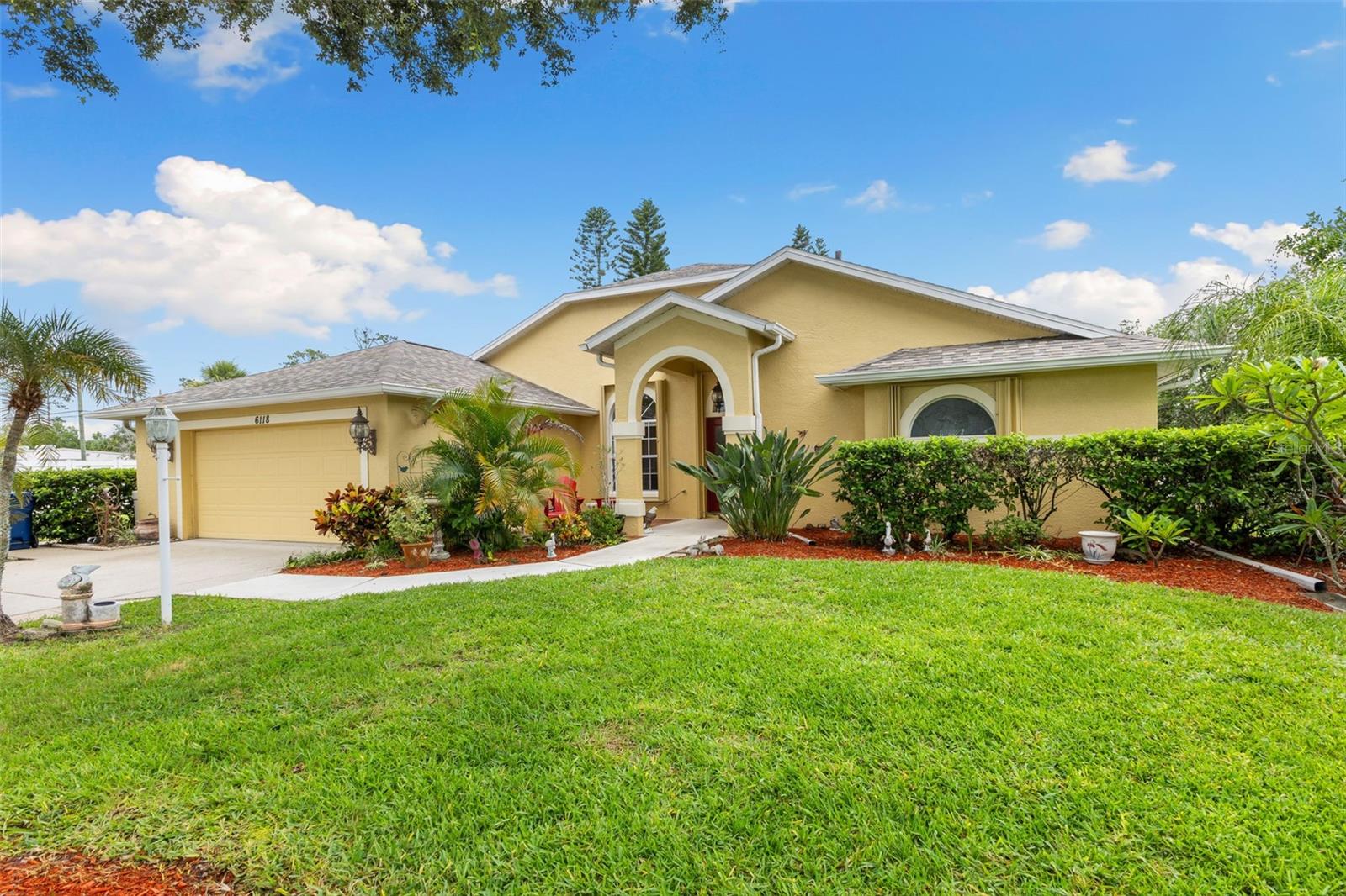 Welcome to your Florida dream home! Before you even step inside, take a moment to appreciate the tranquil pond and cozy sitting area just outside the front entry—perfect for morning coffee or evening relaxation. Step through the foyer and into the spacious living area, where high ceilings and fresh interior paint create a bright, right-at-home feel. Large sliding glass doors seamlessly connect the indoor living space to the screened pool area, the true heart of the home that defines the Florida lifestyle. This thoughtfully designed split floor plan offers privacy and comfort. The primary suite is a true retreat, featuring its own access to the pool area and a luxurious en suite bathroom, the luxurious tiled shower with separate jacuzzi bath feels like a private resort. The living room offers a cozy touch with a fireplace and additional access to the pool—perfect for indoor-outdoor entertaining. The kitchen is complete with stainless steel appliances, granite countertops, breakfast bar, a spacious pantry, and a reverse osmosis system that runs from the kitchen into the garage. A water softener system adds to the home’s many conveniences. The private backyard offers endless possibilities for gardening, entertaining, or simply enjoying the peaceful surroundings. Hurricane shutters and a newer roof, installed in 2022, provide added peace of mind, security and credits towards homeowner's insurance premiums. Located in a prime area close to everyday essentials, great shopping near University Town Center and just a short drive to world-famous beaches like Siesta Key, Longboat Key, and Anna Maria Island, this home truly has it all—style, comfort, and an unbeatable location. Don’t miss your chance to own this slice of paradise!