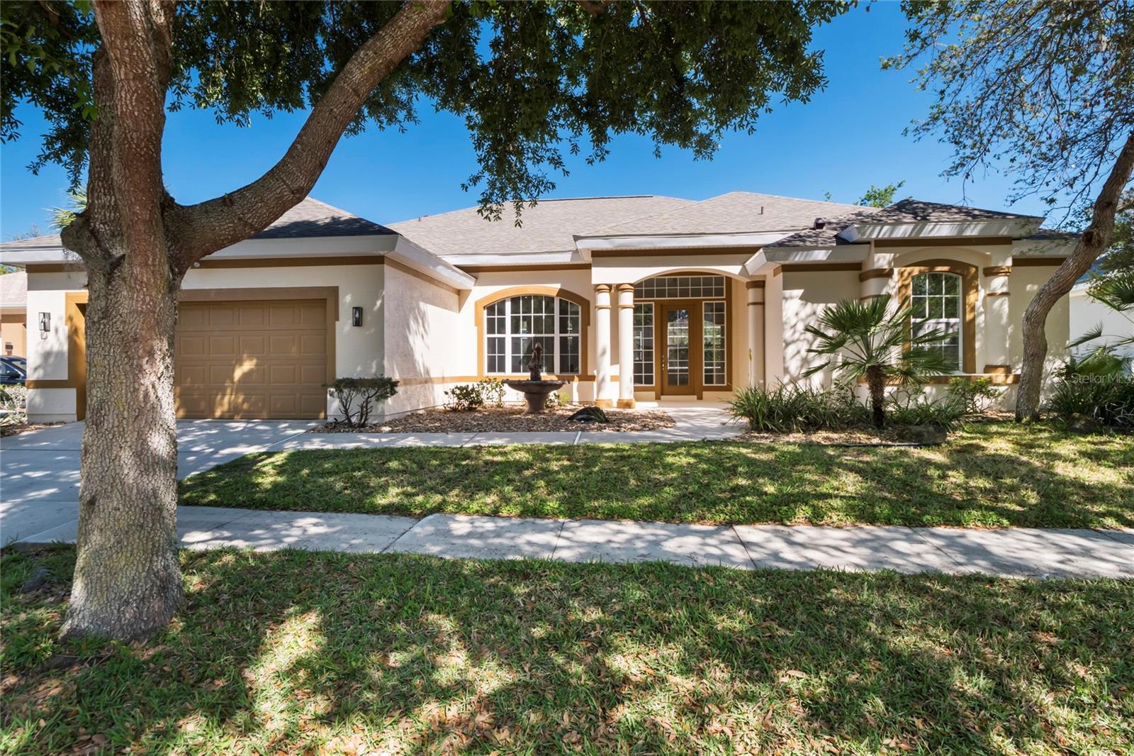 Welcome to your dream home! This stunning 4-bedroom, 2-bath with a HUGE solar heated in-ground pool and spa boasts 12-ft ceilings throughout all living areas and a beautiful open floor plan. Family room has gas fireplace and wall of windows which makes it amazingly light and bright, formal living and dining room are all perfect for entertaining guests. The largest swimming pool you've ever seen, fully enclosed with a screened-in lanai (completely updated 2023) and large under roof outdoor area, adding an extra layer of privacy and comfort and making it ideal for year-round use.The home has been recently renovated, with a new roof installed in 2022, fresh interior and exterior paint, and newer appliances. NEW LVP flooring is present throughout the entire home, giving it a modern and sleek look. Beautiful kitchen with tall natural color cabinets and stainless appliances. Breakfast nook. Large counter space makes it easy for cooking and entertaining family and friends at the same time.Primary bedroom suite is spacious and features a tray ceiling and double slider leading to the pool area. Luxurious ensuite master bath with his and hers walk-in closets with built-ins, and his and hers vanities and large garden tub as well as walk-in shower makes it the ultimate place to relax and unwind in privacy. The split bedroom floor plan allows for additional privacy, with the other three bedrooms located on the opposite side of the home sharing a 2nd bath which also leads to the pool. Portable generator plug will run all lights and appliances with portable generator. The home is located in a beautiful and famous gated community of Grand Haven, which offers a range of amenities, including two community pools, miles of intracoastal trails, tennis courts, pickleball courts, bocce courts, croquet, two gyms, and two restaurants as well as Jack Nicklaus golf course. You'll be just minutes away from the beach, as well as some of the Palm Coast's best shopping, dining and entertainment in the area. Solar water heater 2017, 15 Seer HVAC 2015, Roof 2022. Located in the most amazing community in Palm Coast with lots of amenities such as Golf, Tennis, Pickleball, 2 community pools, 2 gyms, miles of walking and biking trails . Only minutes to beautiful beaches and many different parks. Shopping, dining, hospital all within minutes drive.