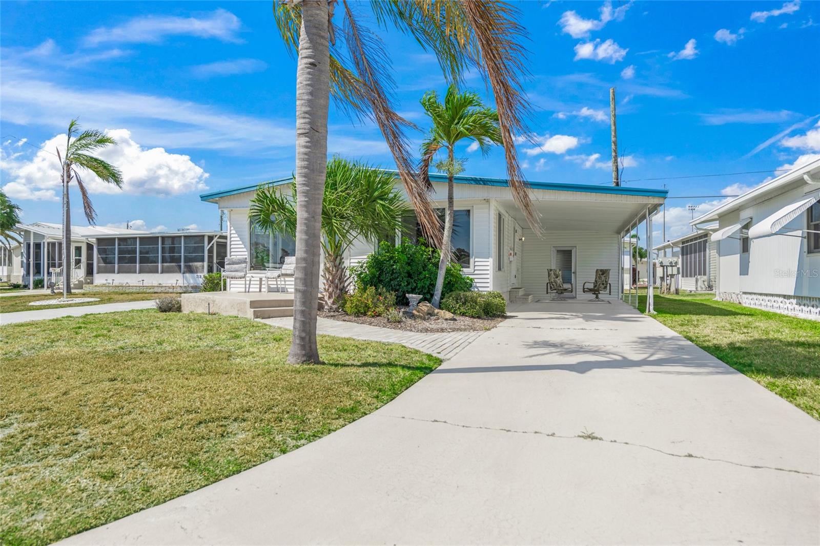 Location, location, location! Amazing water views from this gorgeous home in Country Club Estates, a sought-after 55+ Venice community. A boater's dream on the intracoastal waterway with access to dock and lift privileges. The CCE community has NO lot lease fees and you OWN the lot as well as the mobile home. Enjoy low HOA fees for this maintenance-free community with close proximity to restaurants, parks, walking/biking trails, and beautiful downtown Venice! This unit is sold fully turn-key furnished. Enjoy the spectacular Intracoastal water views from the large, sun-soaked Bonus Room at the front of the home. This space is ideal for additional living, dining, office, or entertainment space. The attached carport and utility space features a new washer, dryer, shelving, and tons of room for recreational storage and other items. Don't miss the opportunity to view this home today!