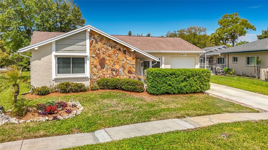 This 3 bedroom, two bath home is a fantastic find where you can live the Florida Lifestyle with financial peace of mind knowing this is NOT a flood zones, there are NO CDD fees, and extremely low HOA fees. This lovely home has it all: a modern kitchen with quartz counter tops and integrated sink, luxury vinyl plank flooring, the combination of a private front courtyard and screened lanai overlooking the large fenced back yard. Beacon Woods East is a designated Bird Sanctuary with ample sidewalks to enjoy walking and biking. The Clubhouse offers a huge salt water pool, tennis courts and scheduled activities. All of this within a short distance of the Suncoast Highway, giving you quick access to the Tampa Airport, world class beaches and many attractions such as Busch Gardens and Adventure Island.