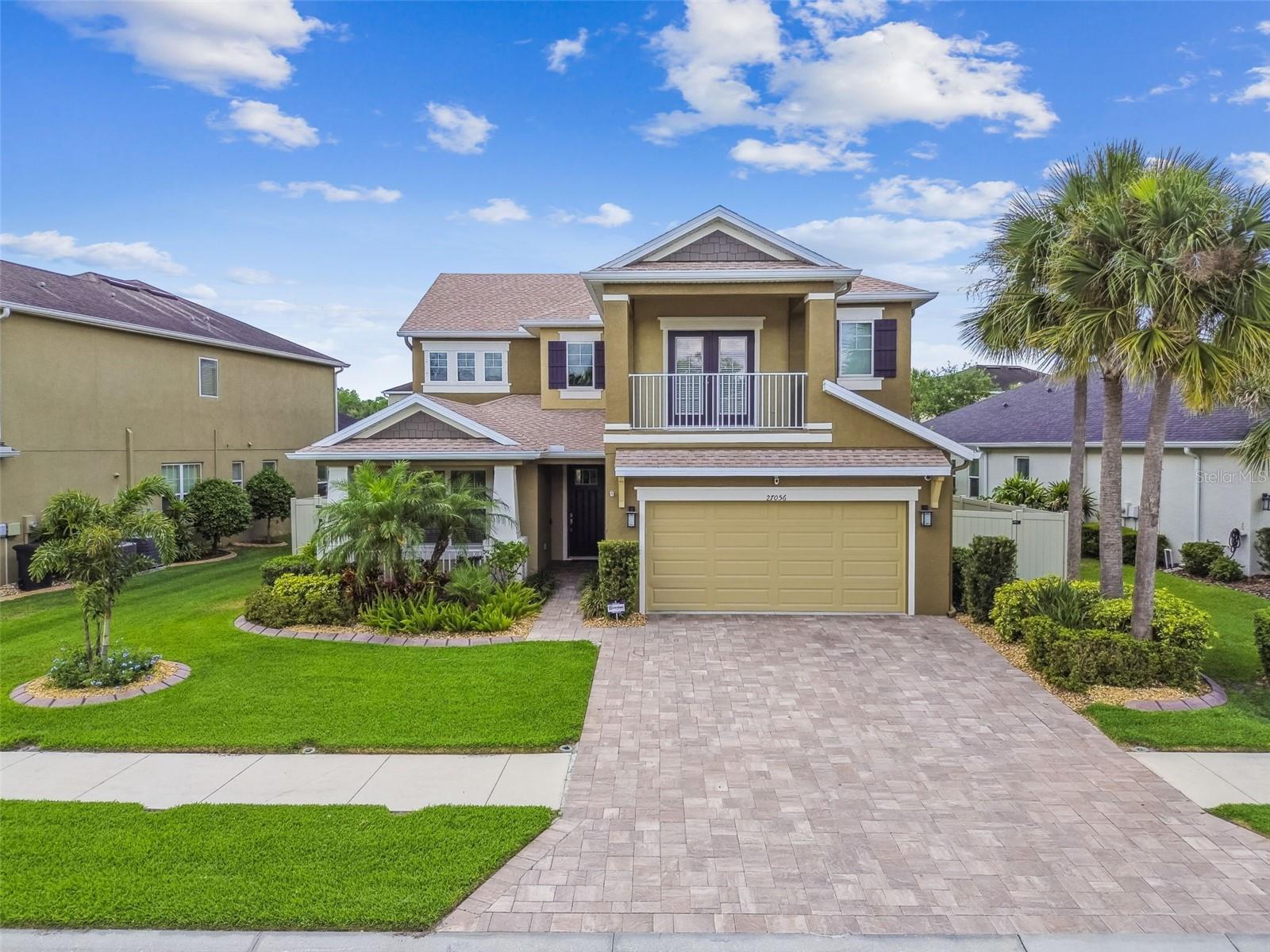 LIKE NEW HOME now available in the highly desired GATED community of Arbor Woods in Wesley Chapel. Zoned for top rated schools! This functional floor plan is a semicustom Taylor Morrison built home with high-end finishes. This impeccable home offers a PRIVATE POOL and SPA, 4 large bedrooms, 3 ½ bathrooms, massive bonus room/loft, formal dining room, home office space, dinette, mud room, and a 3-car tandem garage with raised ceiling shelving. This home is immaculately maintained and offers the best quality of construction, upgrades, energy efficiency, and is on reclaimed water so utilities are LOW. The BRICK PAVER DRIVEWAY leads to the cozy FRONT PORCH and well landscaped exterior where mornings can be spent sipping coffee. There is a dedicated MUD ROOM with custom cabinetry, additional closet storage, and UTILITY SINK upon entering the home. The open concept plan has a large family room with a view of the glistening pool and spa. The backyard provides ultimate relaxation with a brick paver pool deck, HEATED POOL, LUXURY OVERFLOW SPA, SALTWATER system, and waterfall sounds from the upgraded pool fountain bowls. The pool has bench seating all the way around with a SUN SHELF. The FULLY FENCED backyard gives all the privacy needed and offers an artificial TURF area for kids play or pets. The gourmet kitchen is extraordinary showcasing 42-inch wood cabinetry, stainless steel in-wall appliances and GAS range, thick quartz countertops, glass subway tile backsplash, giant center island with under cabinet storage and counter height seating. The upgrades are endless providing CAMERA security system, tankless water heater, high ceilings, wood plank tile throughout the main areas for easy cleaning, crown molding, upgraded 8” doors downstairs, CUSTOM glass slider blinds, upstairs laundry room with custom cabinetry, utility sink pre-plumbing, quartz counters throughout, custom home office cabinetry, and more! Working from home or necessary desk space for homework has never been more functional with these built-in drawers and counters. The space has various uses and can also be made into an entertaining space with a private bar and lounging area; the options are endless. This split plan has generous living space providing over 3,200 SF. The peaceful master suite includes a PRIVATE BALCONY with French doors, walk-in closet, double sink vanities, separate shower, and soaking tub. The loft area is limitless; it can be a movie room, playroom, and so much more. This home provides abundant storage throughout the entire home with upgraded wood shelving. Centrally located near I75, I275, hospitals, Center Ice, Wiregrass Mall, The Grove, Tampa Premium Outlets, KRATE Micro Shops, the newest PopStroke minigolf attraction by Tiger Woods. There is so much to enjoy within this home, in the gates of the community, and all around the amazing area of New Tampa/Wesley Chapel.