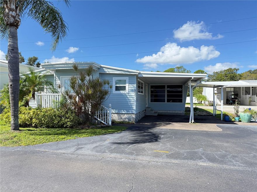 No storm damage to this 1962 home with almost 1200 sq ft of living area.  This home has so much potential for the right buyers with 2 Bedrooms, 2 Baths, and den, or extra space could easily transform into a 3rd bedroom.  Get ready to entertain for the Holidays in the large     22 X 22 Living/Dining combo area.  The kitchen has a gas range and large eating area with lots of cupboards.  Newer LG washer & dryer are located inside the kitchen area.  The large main bath is located by the kitchen and has an updated step in shower and additional cabinets in the hallway.  The 2nd bath has pocket doors for easy access to rooms on each side and has a tub with shower.  Floors are laminate throughout and linoleum in baths and kitchen.  AC (2024), Gas Water Heater (2019), Vapor Barrier (2020), Roof (2016).  The carport has side by side parking for 2 cars, and additional storage in the shed behind home.  Situated in the desirable Gated 55+ Community of Americana Cove, a waterfront community located 10 minutes from Downtown St Pete, 15 minutes to airports, or 20 minutes to the beaches.    Active community with many clubs, shuffleboard, bocce, fitness room, Billiards, Pool and clubhouse.  $380 HOA includes water, sewer, trash pickup and lawn mowing.  675 Credit score required by management.