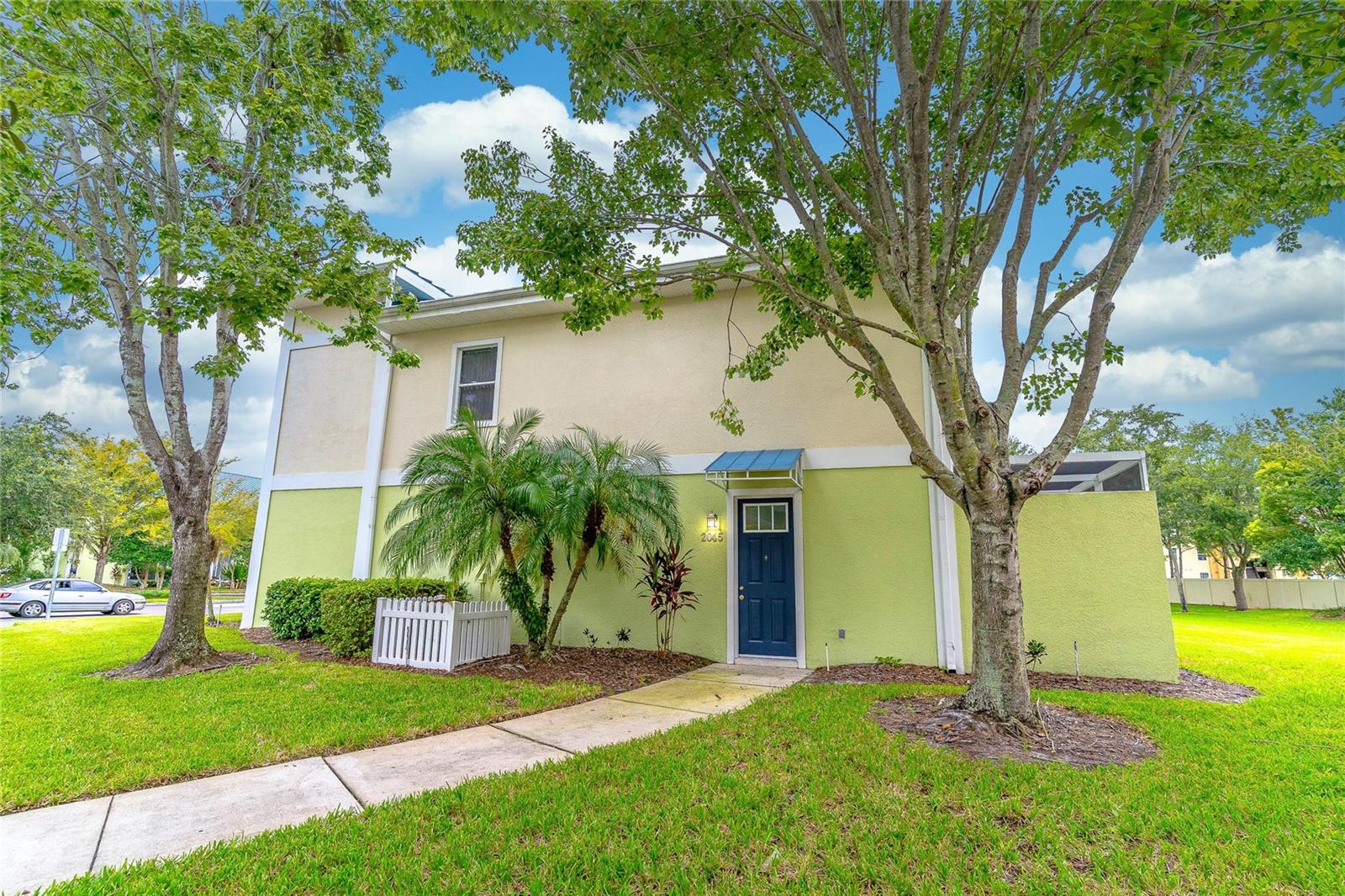 Looks and feels BRAND NEW!! Resort-style living in this upgraded end-unit 4BD/3.5BA townhome located in a desirable gated community. Features include porcelain tile flooring throughout (no carpet), fresh contemporary paint, granite countertops, brand-new stainless steel appliances, and under/over cabinet lighting. The kitchen offers a large island with breakfast bar, walk-in pantry, and abundant cabinet space. Open-concept great room leads to a screened patio with serene views—ideal for entertaining. Dual primary suites—one on each level—feature private baths and generous closets. Two additional upstairs bedrooms share a full bath with separate dual vanity. Upstairs laundry for added convenience. Community amenities include a heated pool and spa, clubhouse, fitness center, game room, playground, and sand volleyball court. Conveniently located near Orlando International Airport, theme parks, shopping, dining, and major highways.