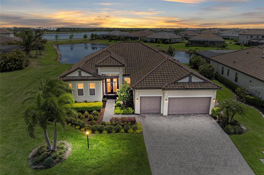 Spectacular home in Lorraine Lakes- situated on one of the very best water-view sites in the neighborhood! This home is PERFECT for those buyers who seek a tranquil lake setting, extra space between neighbors, and nightly sunset views. Lush tropical landscaping and a screened entry welcome you home to an immaculate residence. The sunlit interior offers sparkling lake views with tall ceilings and sliding glass doors that frame the picturesque setting. The gourmet kitchen includes stainless appliances, extended cabinetry, reverse osmosis with faucet, and a pantry with pull out shelves. The split "Sunset" floor plan has a spacious owner’s retreat with two walk in custom closets. The private guest suites are also spacious, and a lovely den offers flexible space. The pool bath offers convenience. The outdoor area is a personal oasis featuring a heated saltwater pool and spa with solar cover and a large lanai perfect for outdoor living. Elegant features include wood plank tile, tray ceiling details, and quartz counters throughout. Many enhancements you’ll appreciate include: professional landscaping, designer lighting and fans, 3 remote hurricane screens, clear hurricane shutters, automated window treatments, plantation shutters, whole home water softener, custom closet systems in main BR, Guest BR, pantry and laundry, garage pulley storage, and more. This better than new home is hurricane ready, energy efficient, and offers plentiful storage. Lorraine Lakes amenities include 24/7 guard gated security, a resort pool, restaurant, tiki bar, pickleball, sports courts, gym, and planned events. Zoned for A-rated schools. See the video tour, and come discover this exceptional residence. Some furnishings available separately.