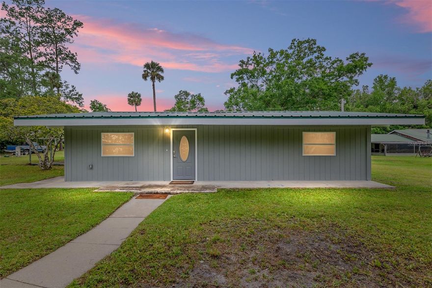 Beautifully updated finishes on this unique custom home in the country near the Ocklawaha River and close to Ocala. This 1638 Living Square Ft home has a metal roof, 2 car carport, updated windows, newer kitchen with custom tiled backsplash wall, white shaker cabinets, poured epoxy counter tops, stainless steel appliances and built in pantry wall. The living and dining area is large and open with high windows, beamed cathedral ceiling and a built in entertainment center. The newer bathroom has a marble look tile floor, large marble top vanity with lots of drawers and a herringbone tiled back splash wall. The whole interior and exterior is freshly painted along with updated lighting & fixtures. There is LVP-Luxury Vinyl Plank in the kitchen, living and dining room. New carpet in the bedrooms along with ceiling fans and a nice size laundry room. New Well so no water or sewer bills here. Just a 10 minute drive to Ocala but in the Ocala National Forest with it's fresh water springs, rivers, lakes for boating & fishing along with hiking, hunting & trail riding. If you want to be away from a crowded neighborhood don't miss this one!