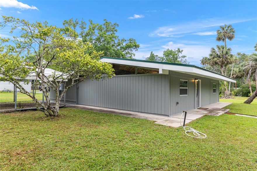 Beautifully updated finishes on this unique custom home in the country near the Ocklawaha River and close to Ocala. This 1638 Living Square Ft home has a metal roof, 2 car carport, updated windows, newer kitchen with custom tiled backsplash wall, white shaker cabinets, poured epoxy counter tops, stainless steel appliances and built in pantry wall. The living and dining area is large and open with high windows, beamed cathedral ceiling and a built in entertainment center. The newer bathroom has a marble look tile floor, large marble top vanity with lots of drawers and a herringbone tiled back splash wall. The whole interior and exterior is freshly painted along with updated lighting & fixtures. There is LVP-Luxury Vinyl Plank in the kitchen, living and dining room. New carpet in the bedrooms along with ceiling fans and a nice size laundry room. New Well so no water or sewer bills here. Just a 10 minute drive to Ocala but in the Ocala National Forest with it's fresh water springs, rivers, lakes for boating & fishing along with hiking, hunting & trail riding. If you want to be away from a crowded neighborhood don't miss this one!