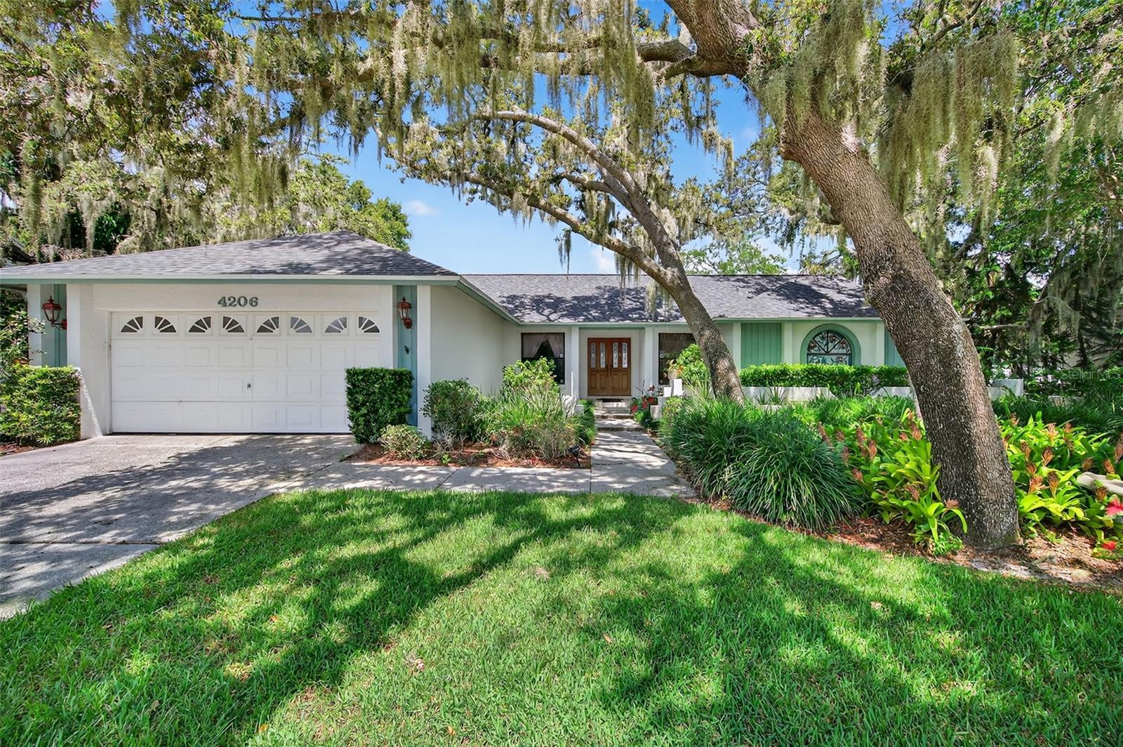 Wonderful in Walden Lake! This ORIGINAL OWNER HOME is just waiting for you to make it your own, as #2 becomes the new #1! 4 BEDROOMS and 2 BATHS in this 2,216 square foot SPLIT FLOOR PLAN in the highly sought-after WALDEN LAKE COMMUNITY, Plant City's finest! Nestled under welcoming, SHADY OAKS on a 1/4 acre lot, you'll feel right at home as soon as you arrive. And you'll definitely see yourself enjoying the HUGE POOL and COVERED & SCREENED LANAI in the privacy of your SPACIOUS, FENCED BACKYARD. Enter the beautiful wood & leaded glass front doors to a large living room / dining room with VAULTED CEILINGS and SKYLIGHTS with a QUADRUPLE SLIDER to the pool / lanai, a stunning view to impress your guests and allowing TONS OF NATURAL LIGHT. The primary suite is on the right side of the home and features Frech doors to the pool, WALK-IN CLOSET, and en suite bathroom with DUAL VANITY, garden tub, and step-in shower. Pocket doors lead to the adjacent 4th bedroom which can be used a HOME OFFICE or a nursery. 2 generously sized secondary bedrooms are situated on the left side of the home and offer a guest bathroom with DUAL VANITY and shower / tub combo. The kitchen is in the rear of the home and has 3 windows to the covered pool area making entertaining a breeze! And the kitchen opens to the inviting family room with vaulted ceilings, WOOD-BURNING FIREPLACE, built-in shelves, breakfast nook, and sliders to the pool. The conveniently placed LAUNDRY ROOM features new WASHER & DRYER, a utility sink, storage closet, and handy folding table! BRAND NEW ROOF gives you peace of mind, and the diligent owner has maintained the 2012 A/C system. Popular Downtown Plant City is just a 10 minute drive - you'll love all the new restaurants, shops, and breweries, not to mention the FAMOUS STRAWBERRY FESTIVAL every year! This home has been lovingly cared for by this 1 owner for over 30 years, and now it's your turn to take this blank canvas to the next level. Can't wait to see what you do with it!